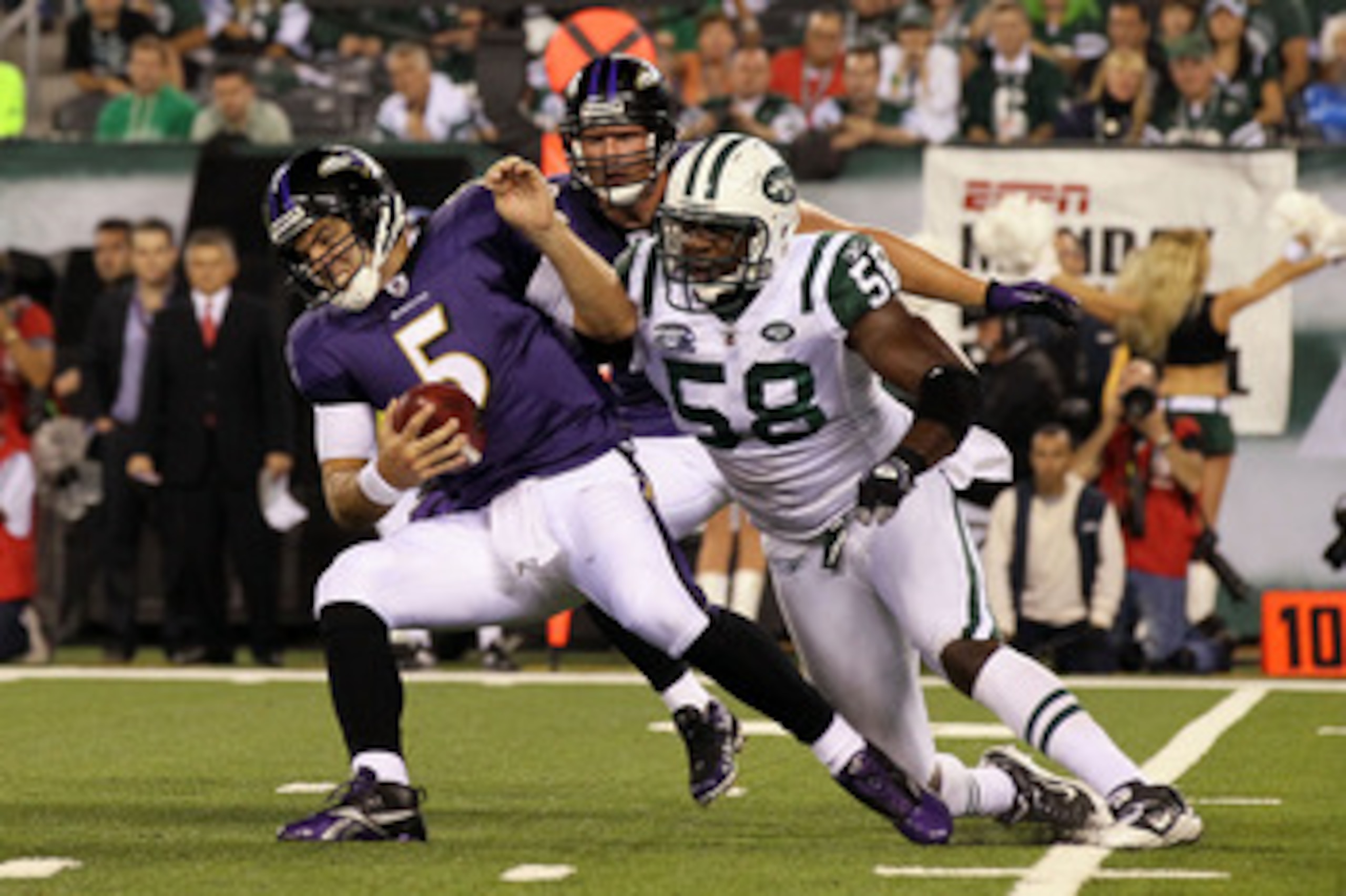 EAST RUTHERFORD, NJ - SEPTEMBER 13: Joe Flacco #5 of the Baltimore Ravens gets sacked by Bryan Thomas #58 of the New York Jets during their home opener at the New Meadowlands Stadium on September 13, 2010 in East Rutherford, New Jersey.  (Photo by Jim McI
