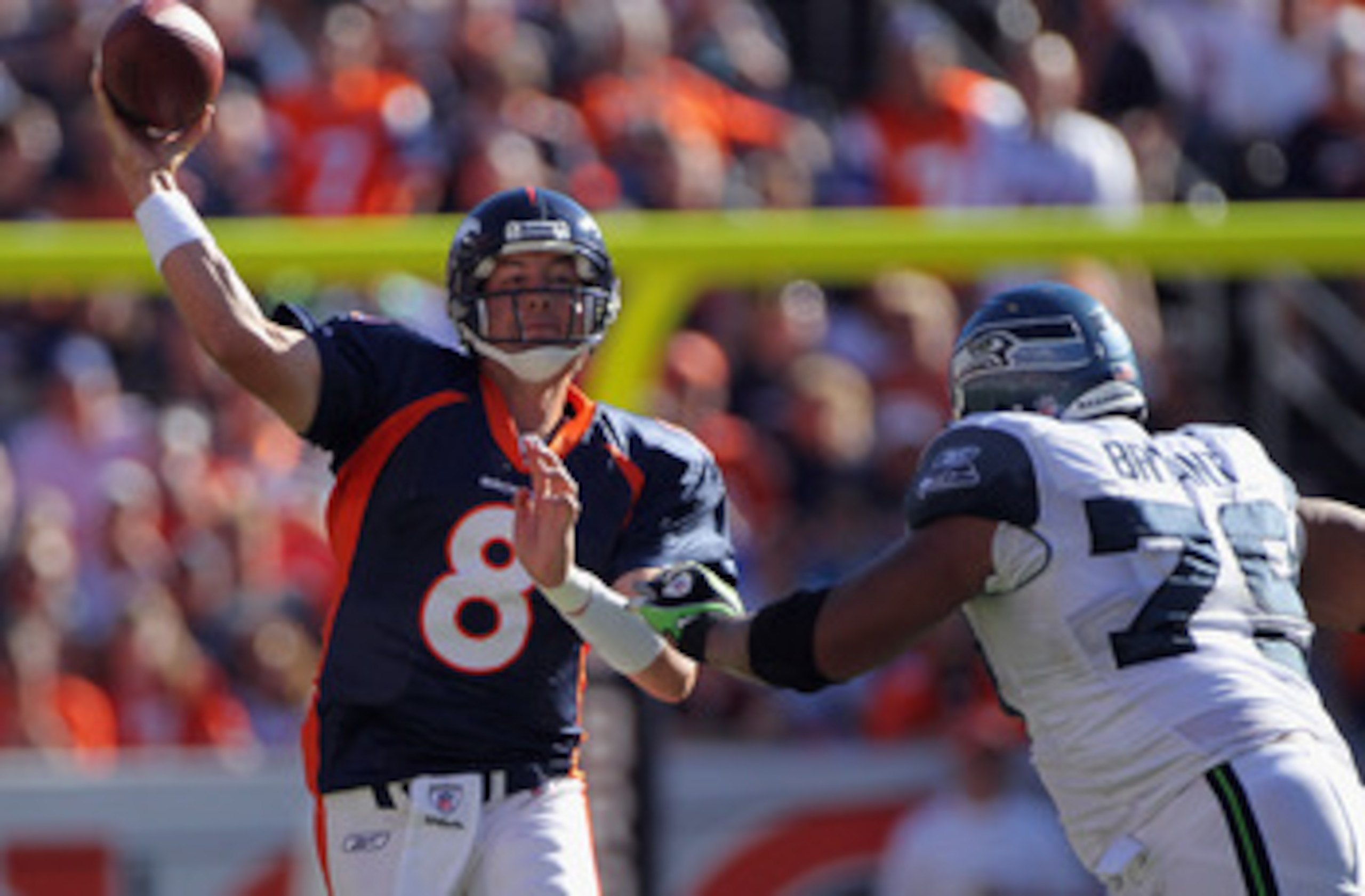 DENVER - SEPTEMBER 19:  Quarterback Kyle Orton #8 of the Denver Broncos gets off a pass while under pressure from defensive end Red Bryant #79 of the Seattle Seahawks at INVESCO Field at Mile High on September 19, 2010 in Denver, Colorado. The Broncos def