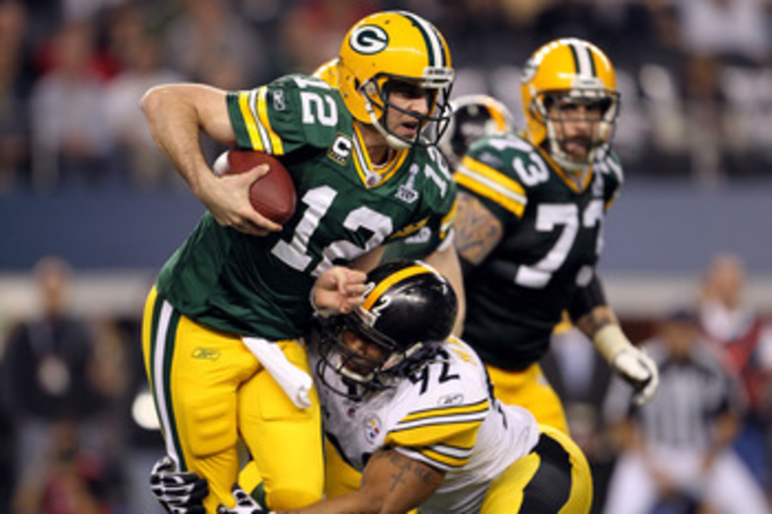 ARLINGTON, TX - FEBRUARY 06:  Aaron Rodgers #12 of the Green Bay Packers is sacked by James Harrison #92 of the Pittsburgh Steelers during the second half of Super Bowl XLV at Cowboys Stadium on February 6, 2011 in Arlington, Texas.  (Photo by Jamie Squir