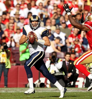 SAN FRANCISCO - NOVEMBER 14:  Sam Bradford #8  of the St. Louis Rams is chased by Manny Lawson #99 of the San Francisco 49ers at Candlestick Park on November 14, 2010 in San Francisco, California.  (Photo by Ezra Shaw/Getty Images)