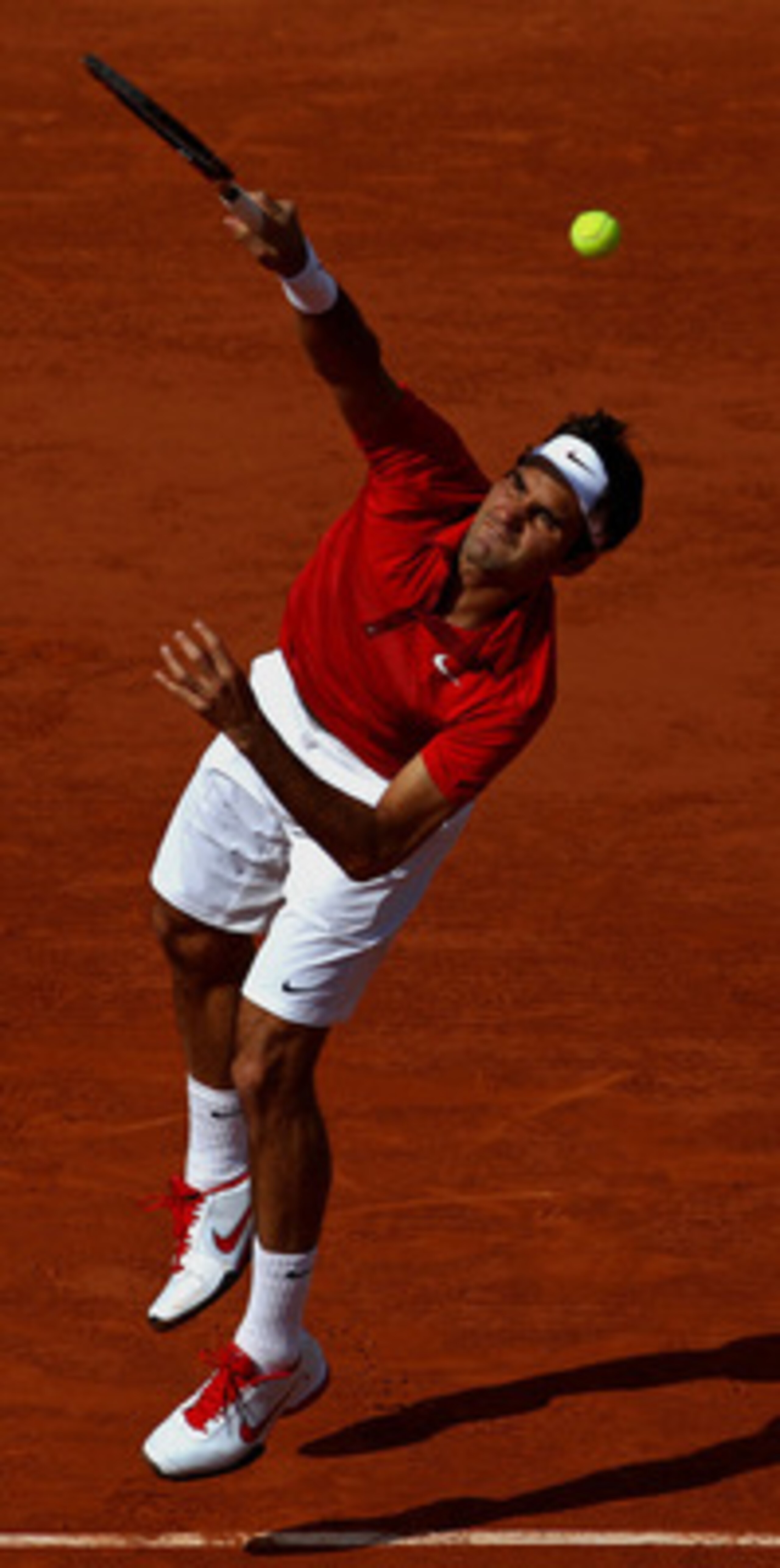 PARIS, FRANCE - MAY 31:  Roger Federer of Switzerland serves during the men's singles quarterfinal match between Gael Monfils of France and Roger Federer of Switzerland on day ten of the French Open at Roland Garros on May 31, 2011 in Paris, France.  (Pho