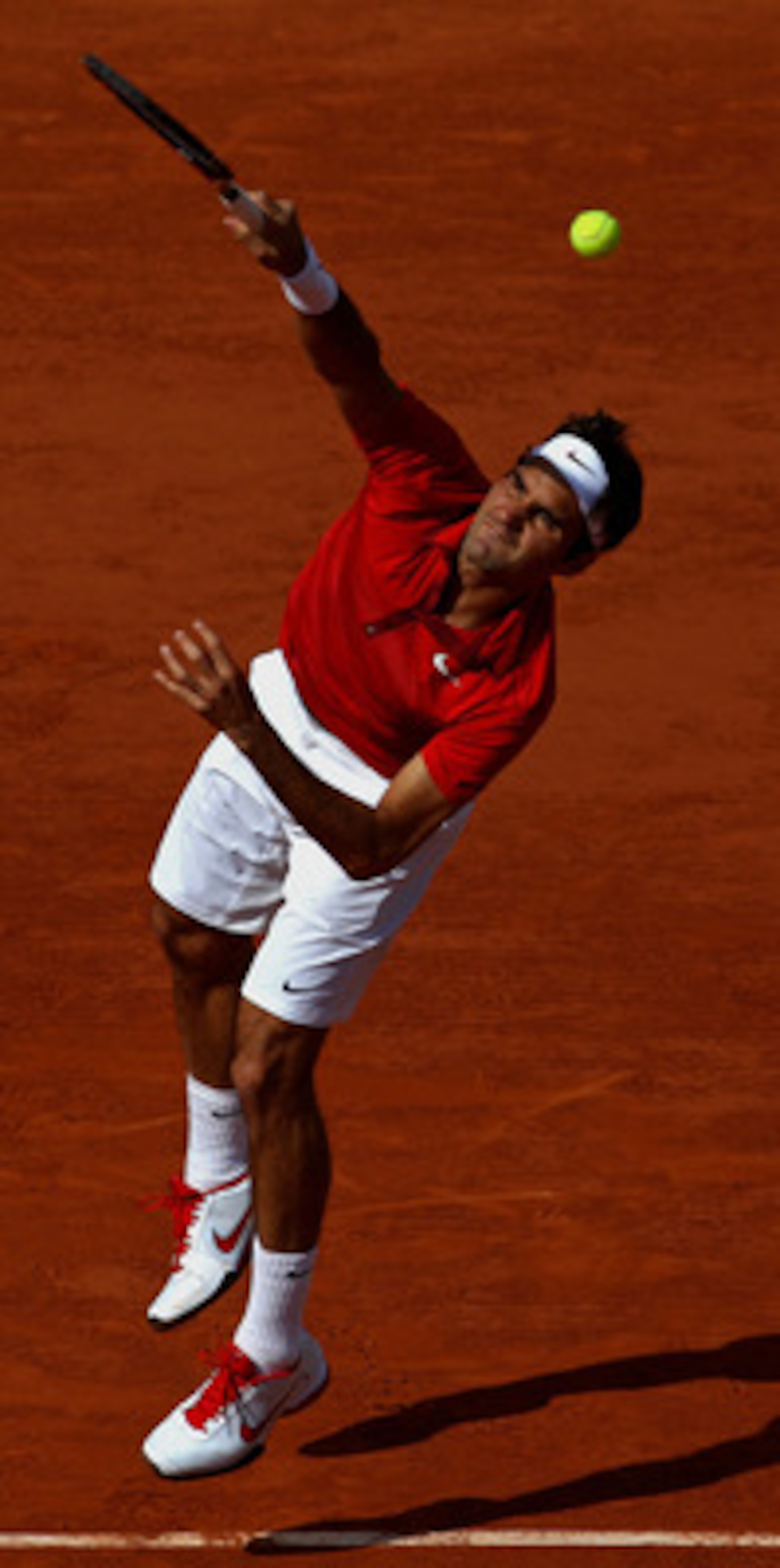 PARIS, FRANCE - MAY 31:  Roger Federer of Switzerland serves during the men's singles quarterfinal match between Gael Monfils of France and Roger Federer of Switzerland on day ten of the French Open at Roland Garros on May 31, 2011 in Paris, France.  (Pho