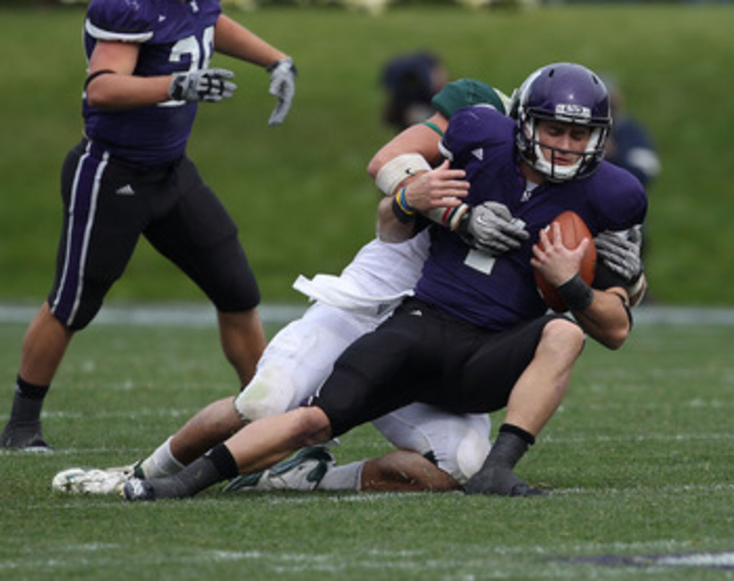 EVANSTON, IL - OCTOBER 23: Dan Persa #7 of the Northwestern Wildcats is sacked by Tyler Hoover #91 of the Michigan State Spartans at Ryan Field on October 23, 2010 in Evanston, Illinois. Michigan State defeated Northwestern 35-27. (Photo by Jonathan Danie