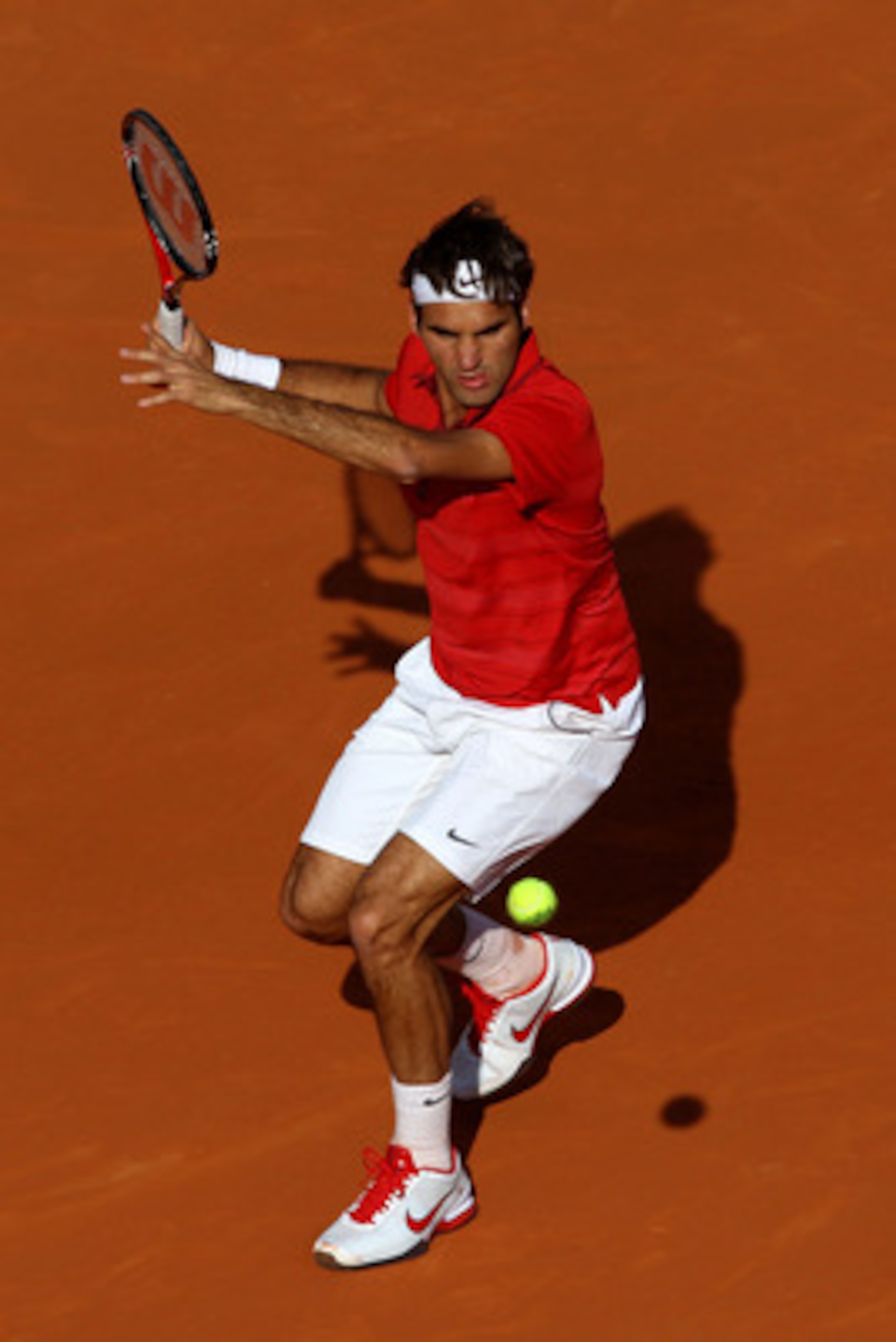 PARIS, FRANCE - MAY 31:  Roger Federer of Switzerland hits a forehand during the men's singles quarterfinal match between Gael Monfils of France and Roger Federer of Switzerland on day ten of the French Open at Roland Garros on May 31, 2011 in Paris, Fran