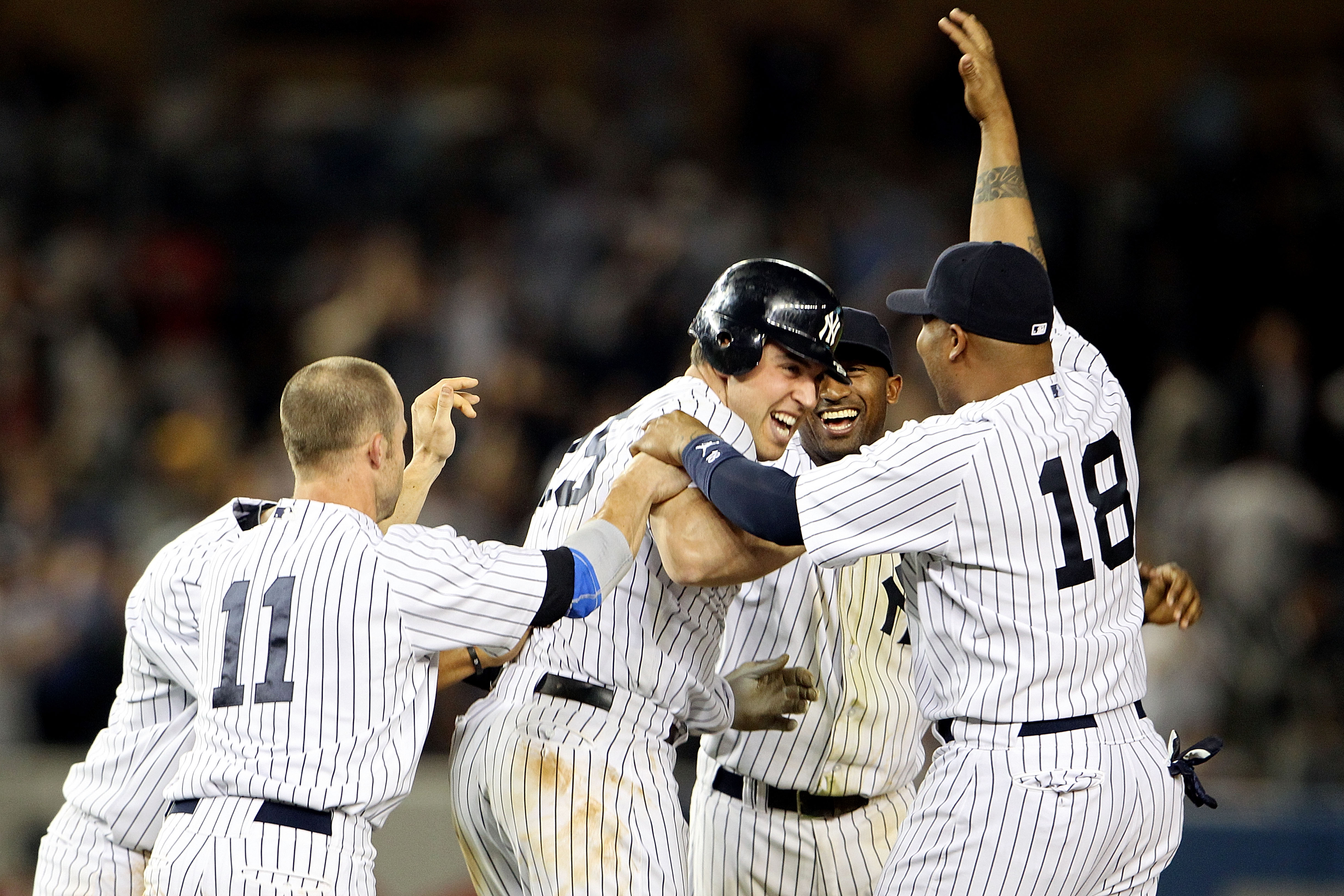 NEW YORK, NY - MAY 24:  Mark Teixeira #25 of the New York Yankees celebrates with Brett Gardner #11 and Andruw Jones #18 after hitting a game winning RBI in the ninth inning against the Toronto Blue Jays at Yankee Stadium on May 24, 2011 in the Bronx boro