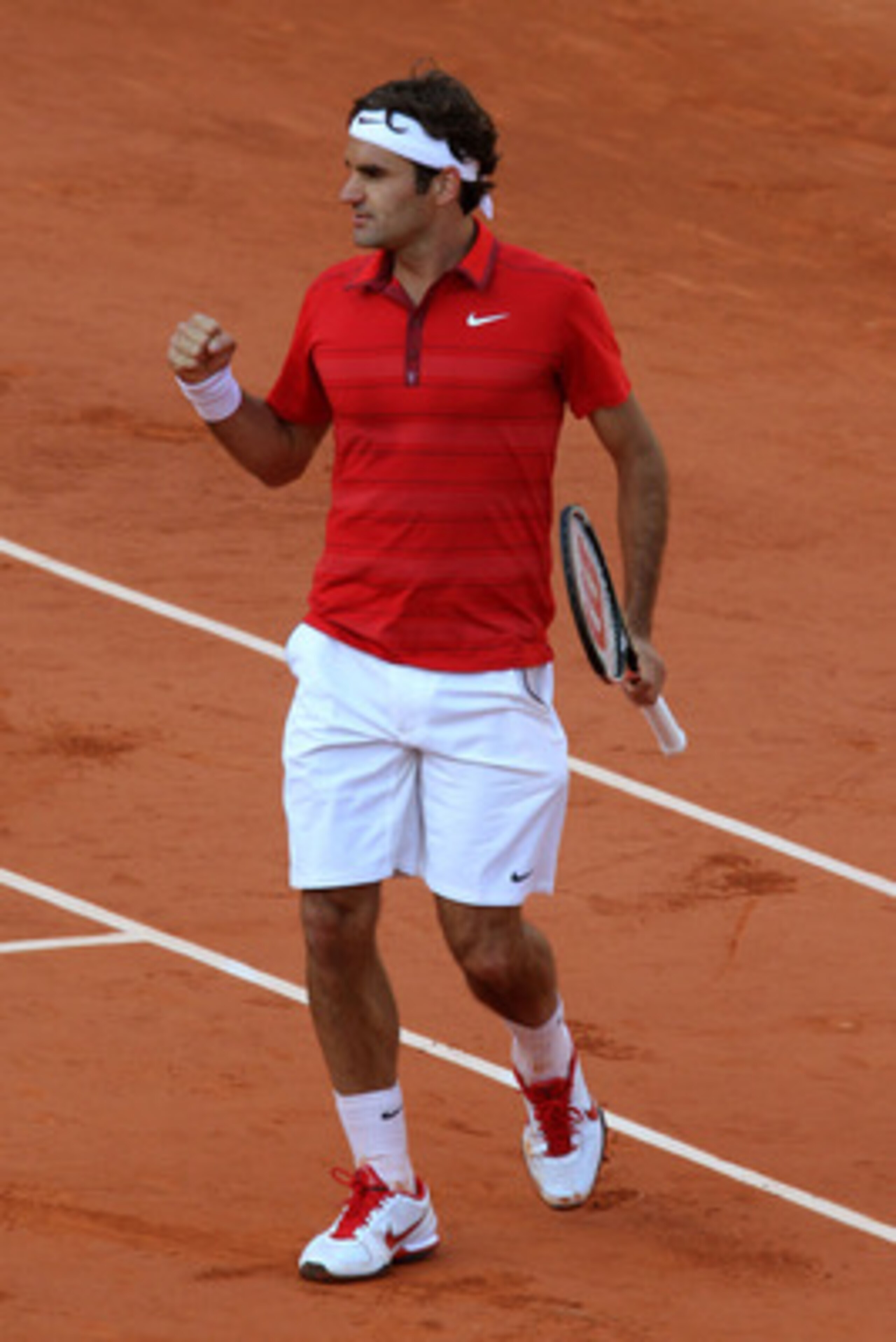 PARIS, FRANCE - MAY 31:  Roger Federer of Switzerland celebrates matchpoint during the men's singles quarterfinal match between Gael Monfils of France and Roger Federer of Switzerland on day ten of the French Open at Roland Garros on May 31, 2011 in Paris