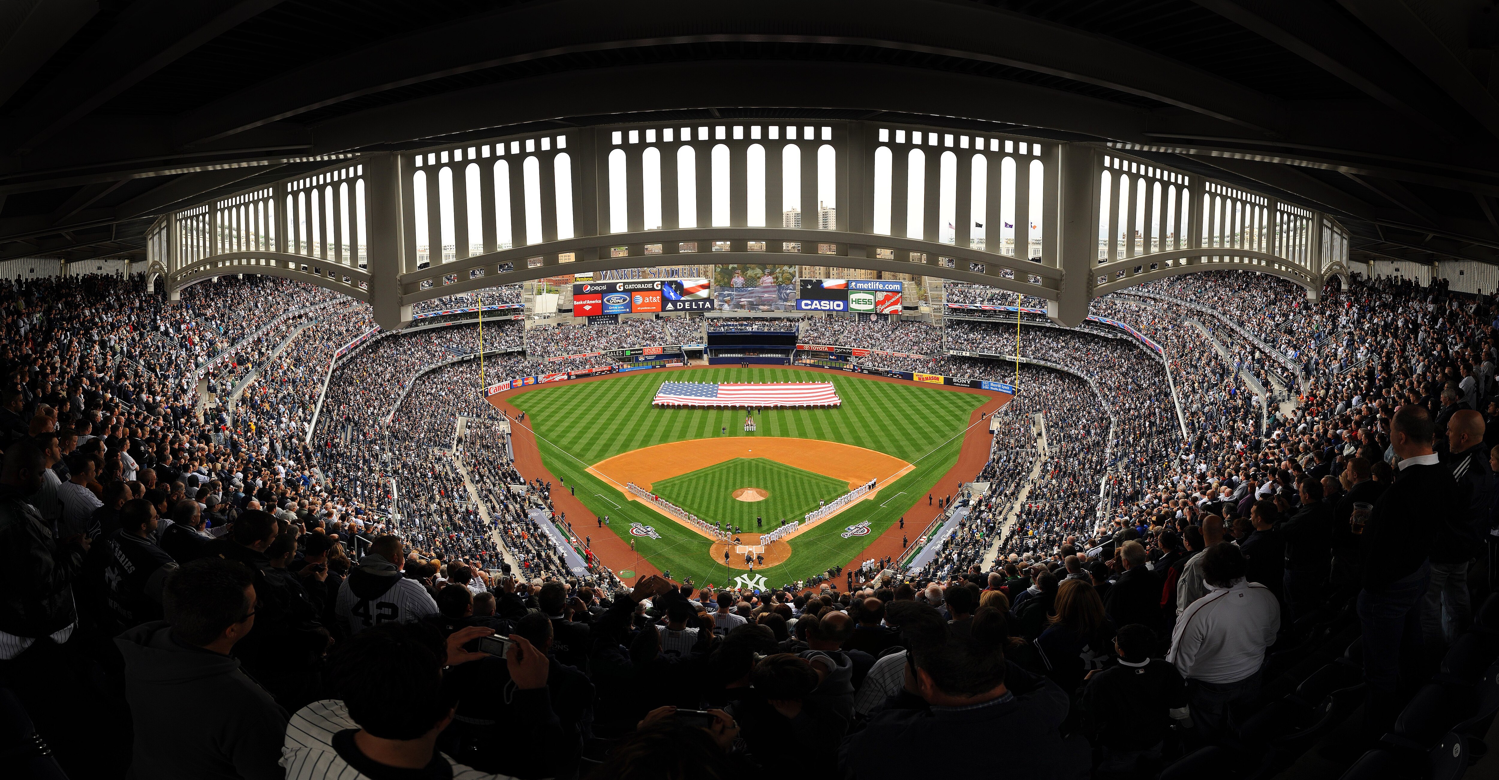 NEW YORK - APRIL 13: (***EDITORS NOTE*** THIS PANORAMIC COMPOSITE IMAGE WAS CREATED USING PHOTO STITCHING SOFTWARE) The New York Yankees and the Los Angeles Angels of Anaheim stand at attention during the National Anthem as a giant American flag is displa