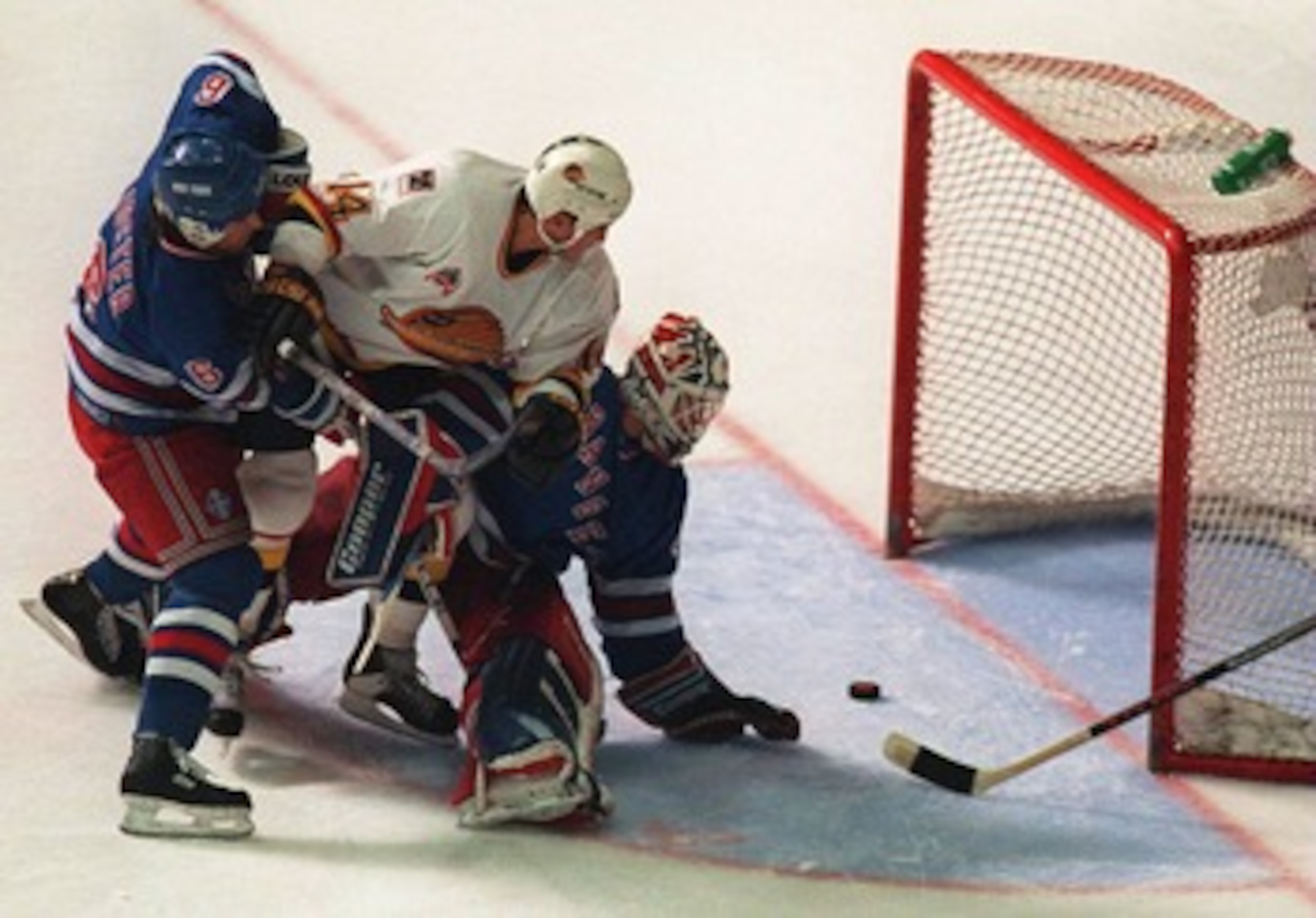 11 JUN 1994: CANUCKS FORWARD GEOFF COURTNALL SLIPS THE PUCK THROUGH THE PADS OF RANGERS GOALTENDER MIKE RICHTER, DESPITE THE EFFORTS OF DEFENSEMAN DOUG LIDSTER, TO GO UP 2-0 IN THE SECOND PERIOD OF GAME SIX OF THE STANLEY CUP FINALS IN VANCOUVER, BRITISH