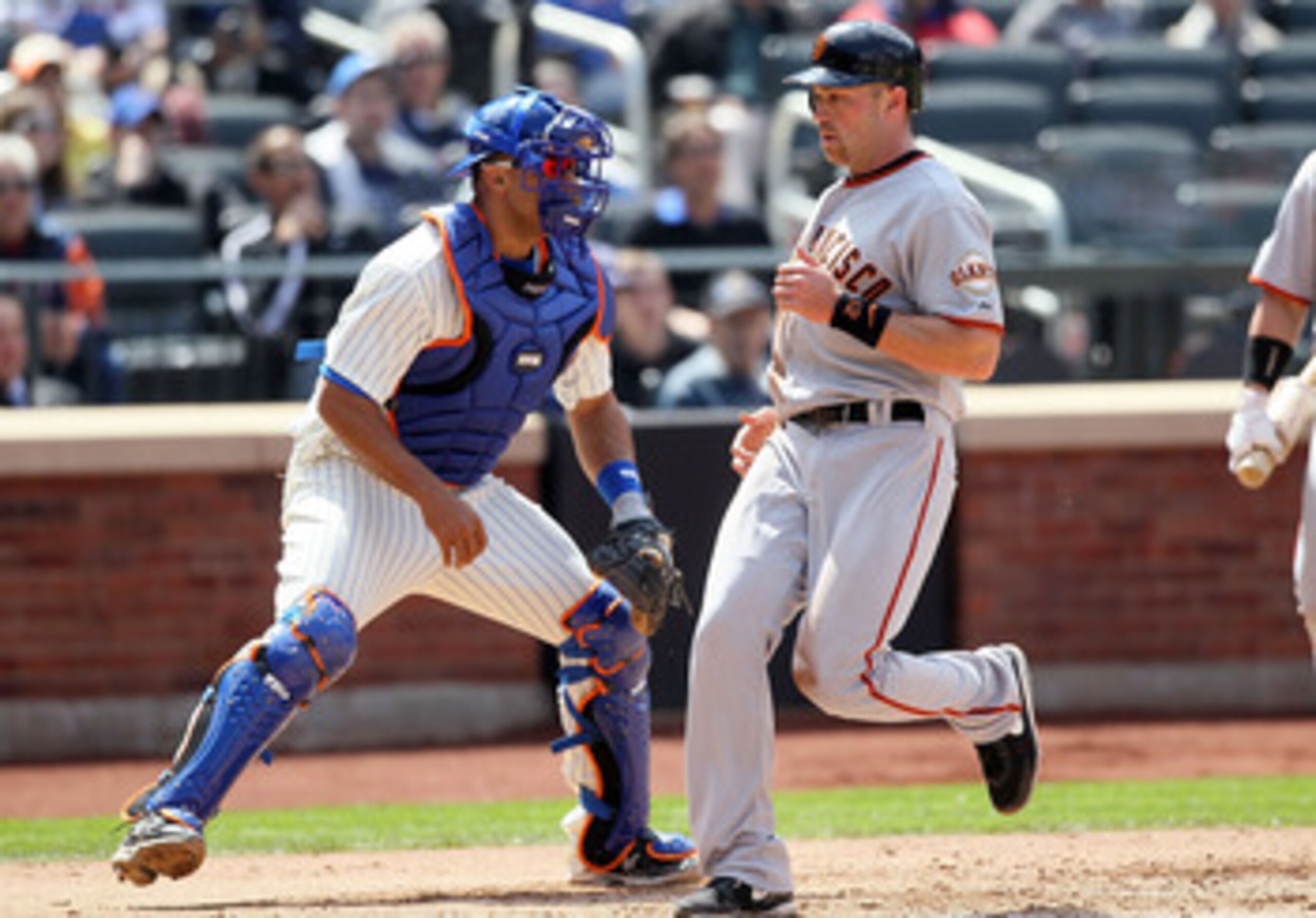 NEW YORK, NY - MAY 05:  Ronny Paulino #9 of the New York Mets waits for the throw as Nate Schierholtz #12 of the San Francisco Giants scores a fifth inning run on May 5, 2011 at Citi Field in the Flushing neighborhood of the Queens borough of New York Cit