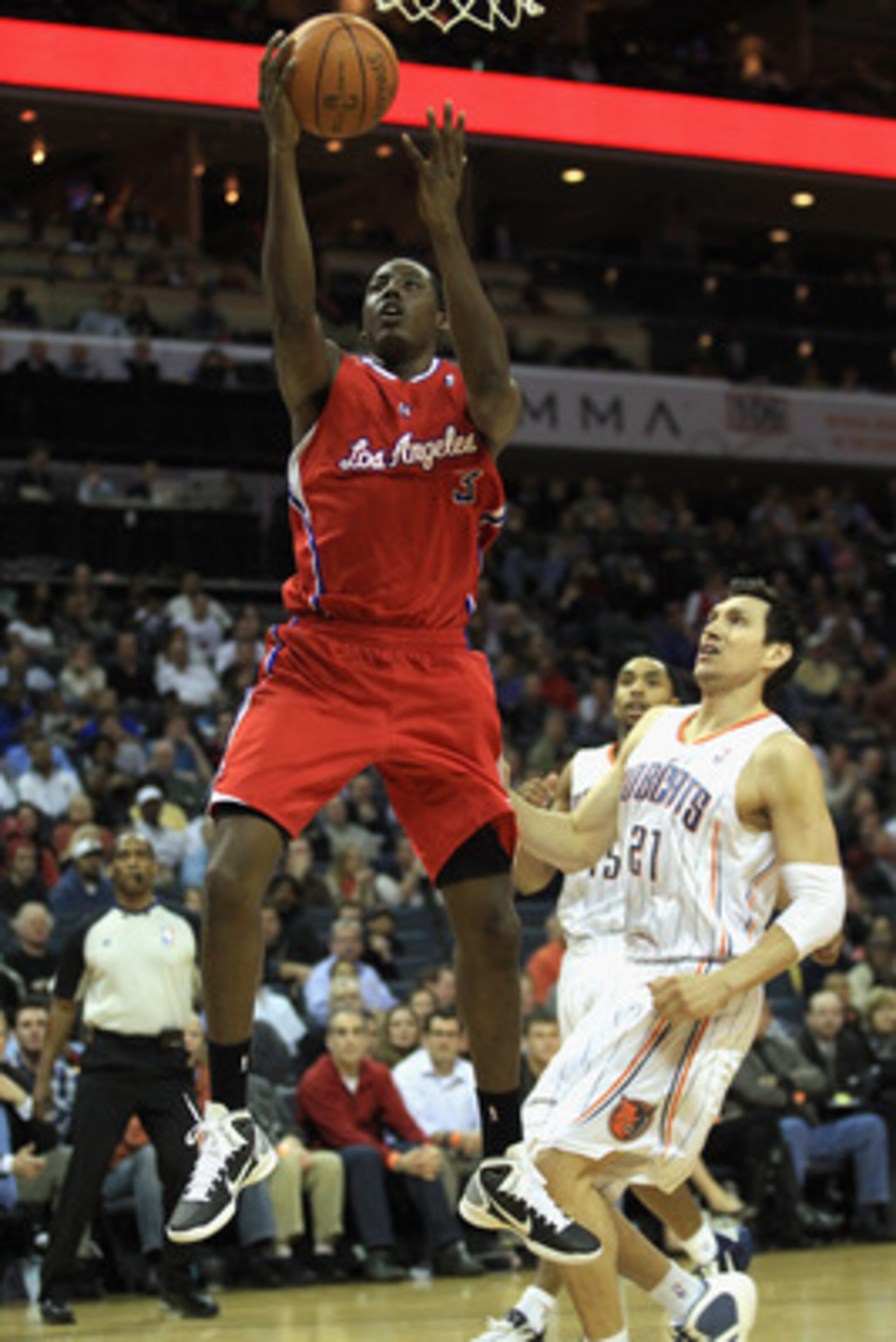 CHARLOTTE, NC - MARCH 07:  Al-Farouq Aminu #3 of the Los Angeles Clippers drives to the basket against Eduardo Najera #21 of the Charlotte Bobcats during their game at Time Warner Cable Arena on March 7, 2011 in Charlotte, North Carolina. NOTE TO USER: Us