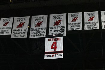 EAST RUTHERFORD, NJ - FEBRUARY 3: A banner retiring the jersey number of defenseman Scott Stevens #4 of the New Jersey Devils, hangs with three Stanley Cup banners for the Devils before their game against the Carolina Hurricanes on February 3, 2006 at the