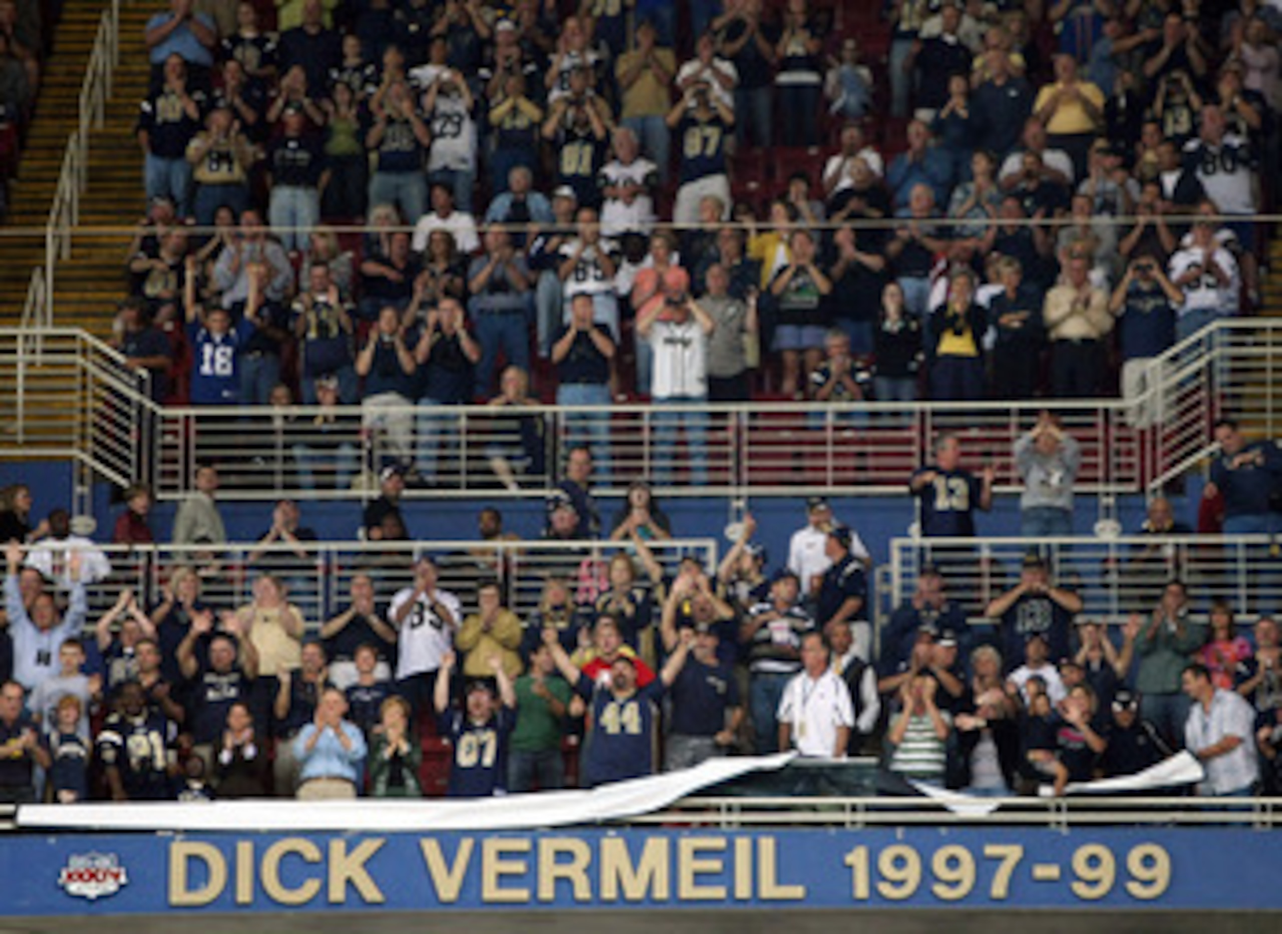 ST. LOUIS - NOVEMBER 02:  Fans celebrate St. Louis Rams former head coach Dick Vermeil as his name is unveiled on the stadium wall during a ceremony to honor the coach on November 2, 2008 at the Edwards Jones Dome in St. Louis, Missouri.  (Photo by Elsa/G