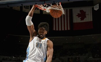 DENVER, CO - MARCH 21:  Nene #31 of the Denver Nuggets dunks the ball in front of Amir Johnson #15 of the Toronto Raptors at the Pepsi Center on March 21, 2011 in Denver, Colorado. NOTE TO USER: User expressly acknowledges and agrees that, by downloading