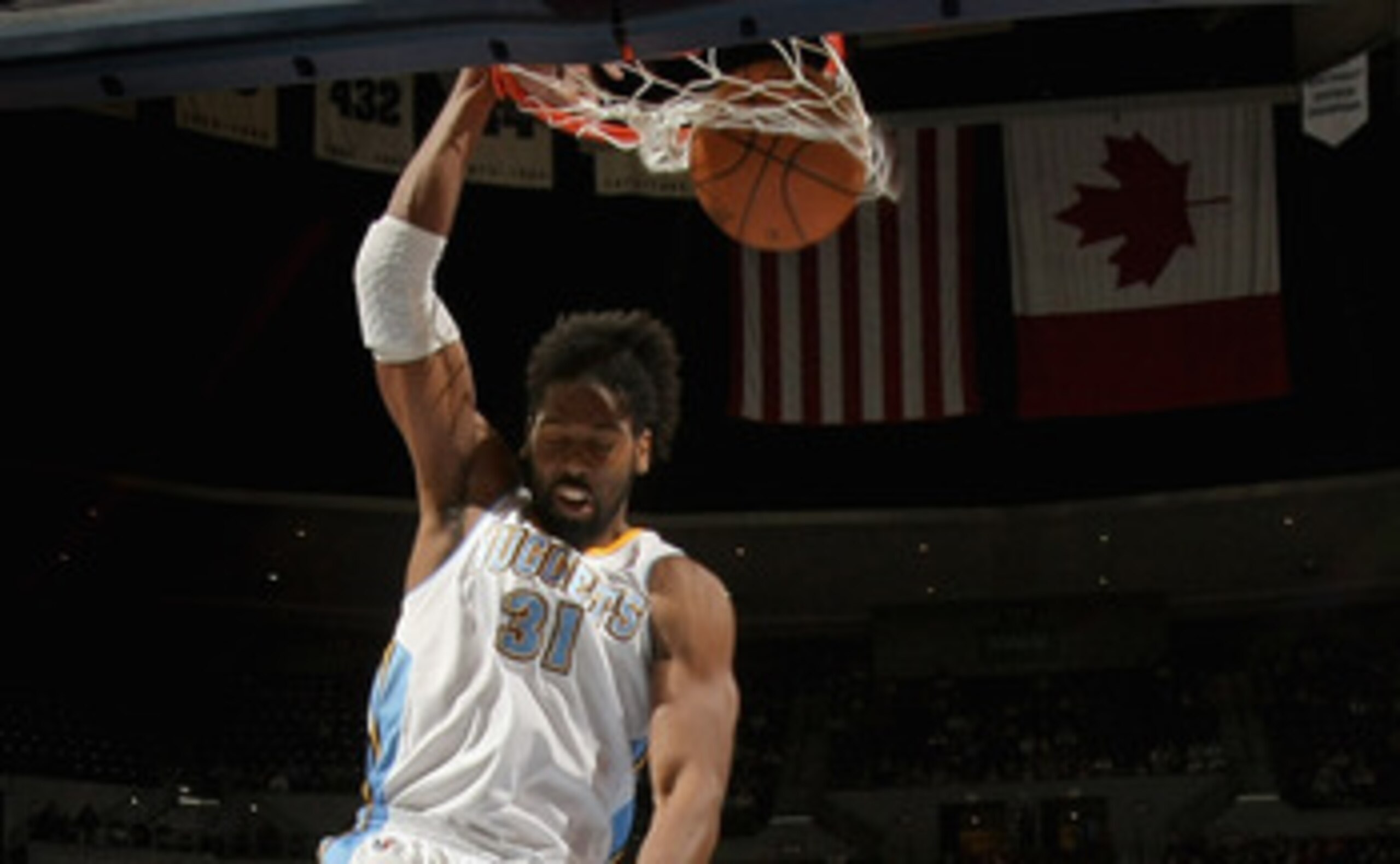 DENVER, CO - MARCH 21:  Nene #31 of the Denver Nuggets dunks the ball in front of Amir Johnson #15 of the Toronto Raptors at the Pepsi Center on March 21, 2011 in Denver, Colorado. NOTE TO USER: User expressly acknowledges and agrees that, by downloading