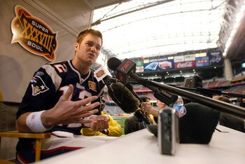 HOUSTON - JANUARY 27:  Quarterback Tom Brady #12 of the New England Patriots answers questions during media day on January 27, 2003 at Reliant Stadium in Houston, Texas. The New England Patriots and Carolina Panthers will play in Super Bowl XXXVIII on Feb