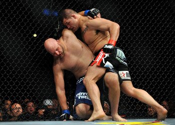 LOS ANGELES, CA - OCTOBER 24:  UFC fighter Cain Velasquez (R) hits UFC fighter Ben Rothwell (L) up against the fence during their Heavyweight bout at UFC 104: Machida vs. Shogun at Staples Center on October 24, 2009 in Los Angeles, California.  Velasquez 