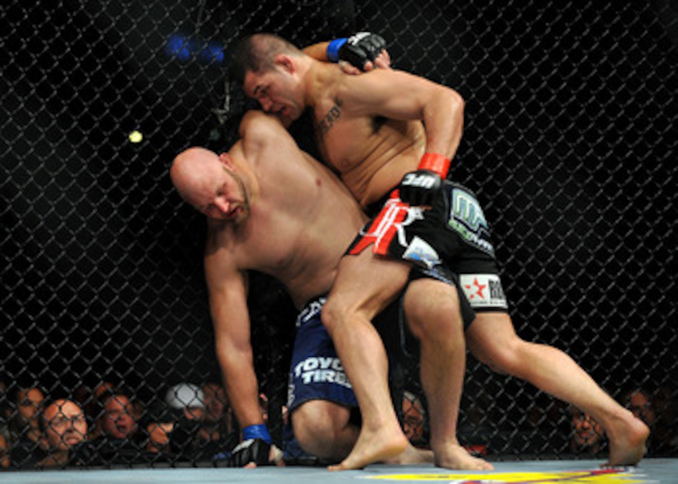 LOS ANGELES, CA - OCTOBER 24: UFC fighter Cain Velasquez (R) hits UFC fighter Ben Rothwell (L) up against the fence during their Heavyweight bout at UFC 104: Machida vs. Shogun at Staples Center on October 24, 2009 in Los Angeles, California. Velasquez LOS ANGELES, CA - OCTOBER 24: UFC fighter Cain Velasquez (R) hits UFC fighter Ben Rothwell (L) up against the fence during their Heavyweight bout at UFC 104: Machida vs. Shogun at Staples Center on October 24, 2009 in Los Angeles, California. Velasquez