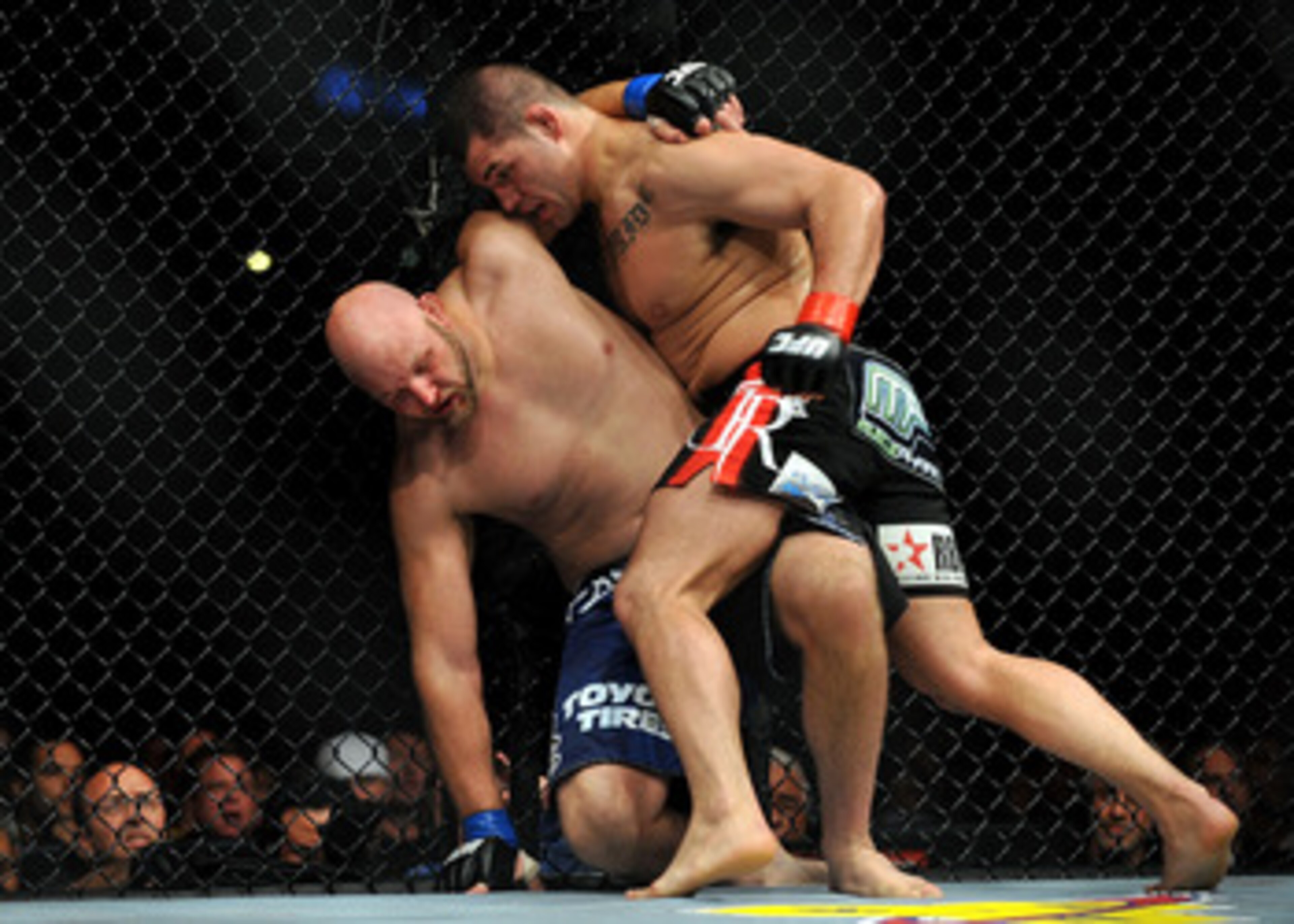 LOS ANGELES, CA - OCTOBER 24:  UFC fighter Cain Velasquez (R) hits UFC fighter Ben Rothwell (L) up against the fence during their Heavyweight bout at UFC 104: Machida vs. Shogun at Staples Center on October 24, 2009 in Los Angeles, California.  Velasquez 