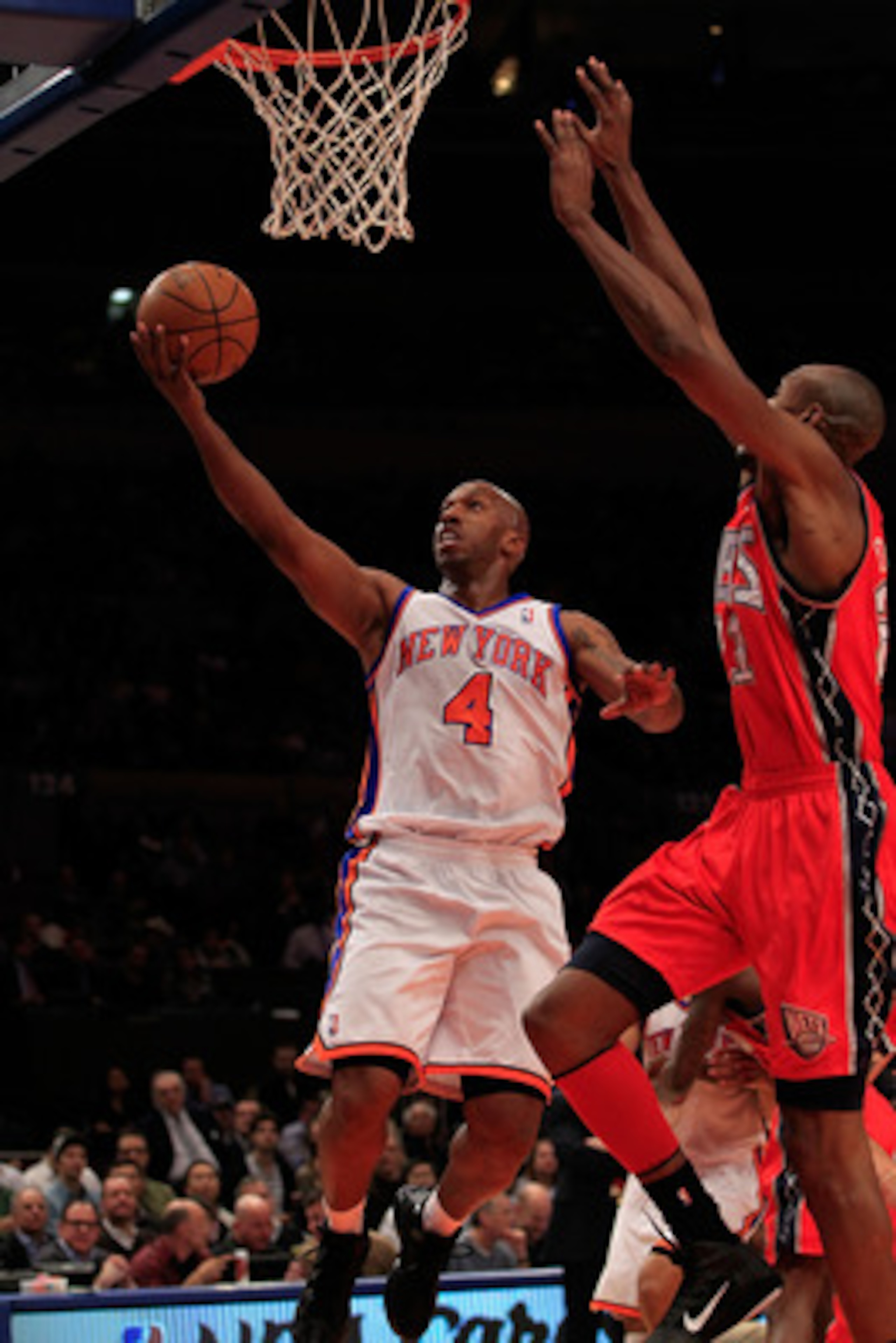 NEW YORK, NY - MARCH 30: Chauncey Billups #4 of the New York Knicks shoots over Travis Outlaw#21 of the New Jersey Nets at Madison Square Garden on March 30, 2011 in New York City. NOTE TO USER: User expressly acknowledges and agrees that, by downloading