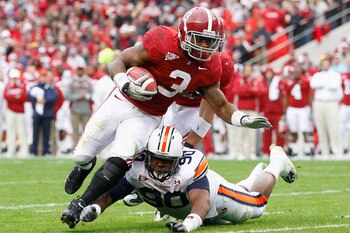 TUSCALOOSA, AL - NOVEMBER 26:  Trent Richardson #3 of the Alabama Crimson Tide is tackled by Nick Fairly #90 of the Auburn Tigers at Bryant-Denny Stadium on November 26, 2010 in Tuscaloosa, Alabama.  (Photo by Kevin C. Cox/Getty Images)