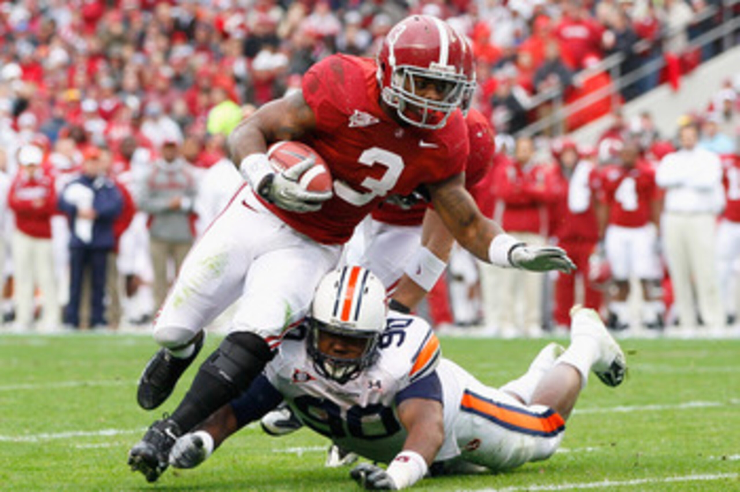 TUSCALOOSA, AL - NOVEMBER 26:  Trent Richardson #3 of the Alabama Crimson Tide is tackled by Nick Fairly #90 of the Auburn Tigers at Bryant-Denny Stadium on November 26, 2010 in Tuscaloosa, Alabama.  (Photo by Kevin C. Cox/Getty Images)