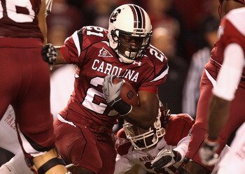 COLUMBIA, SC - NOVEMBER 06:  Jerico Nelson #31 of the Arkansas Razorbacks tries to stop Marcus Lattimore #21 of the South Carolina Gamecocks during their game at Williams-Brice Stadium on November 6, 2010 in Columbia, South Carolina.  (Photo by Streeter L