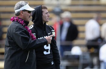 BOULDER, CO - NOVEMBER 13:  Interim head coach Brian Cabral talks with injured quarterback Tyler Hansen #9 of the Colorado Buffaloes during warm ups as they prepare to face the Iowa State Cyclones at Folsom Field on November 13, 2010 in Boulder, Colorado.