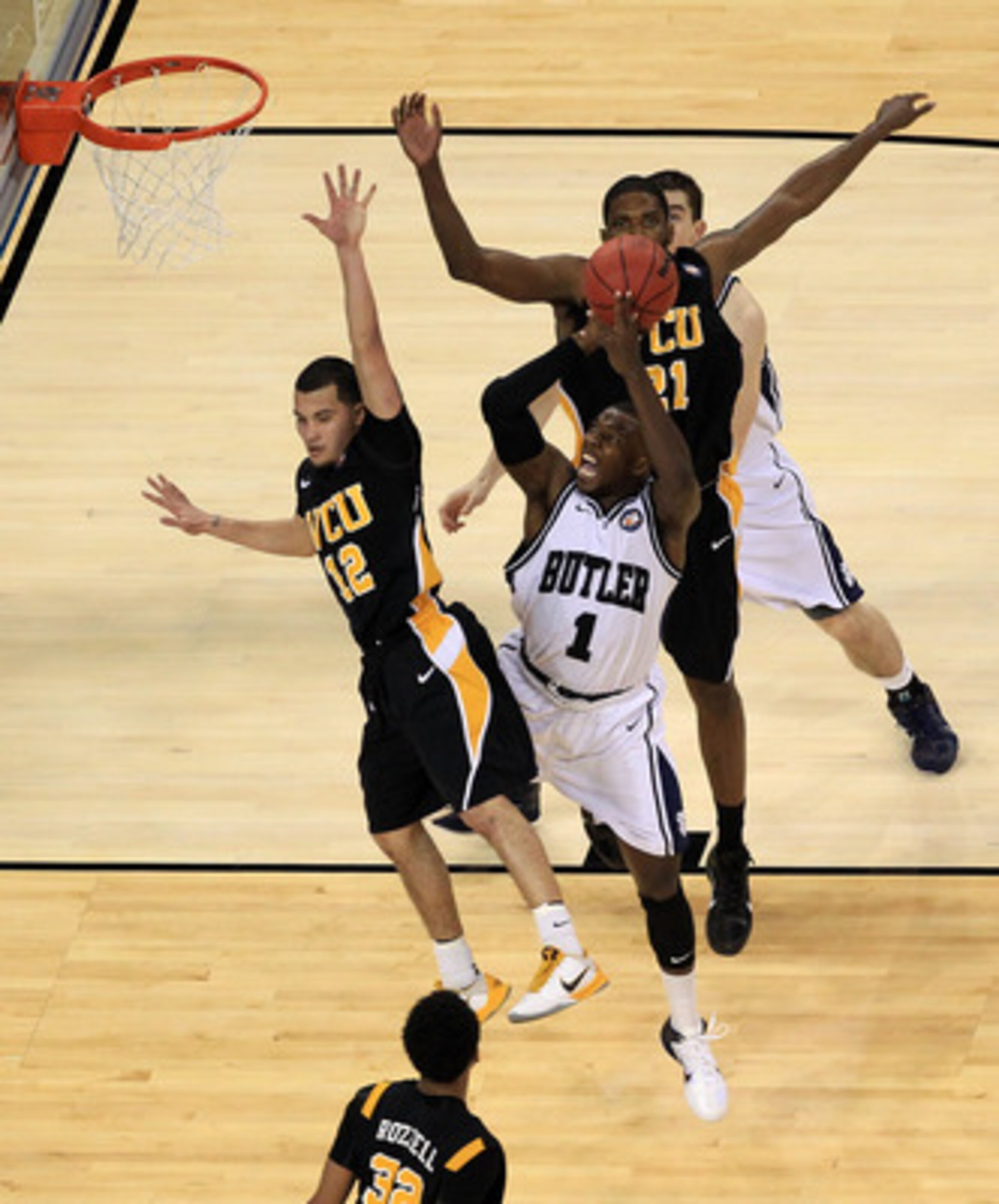 HOUSTON, TX - APRIL 02:  Shelvin Mack #1 of the Butler Bulldogs goes to the hoop against Joey Rodriguez #12 of the Virginia Commonwealth Rams during the National Semifinal game of the 2011 NCAA Division I Men's Basketball Championship at Reliant Stadium o