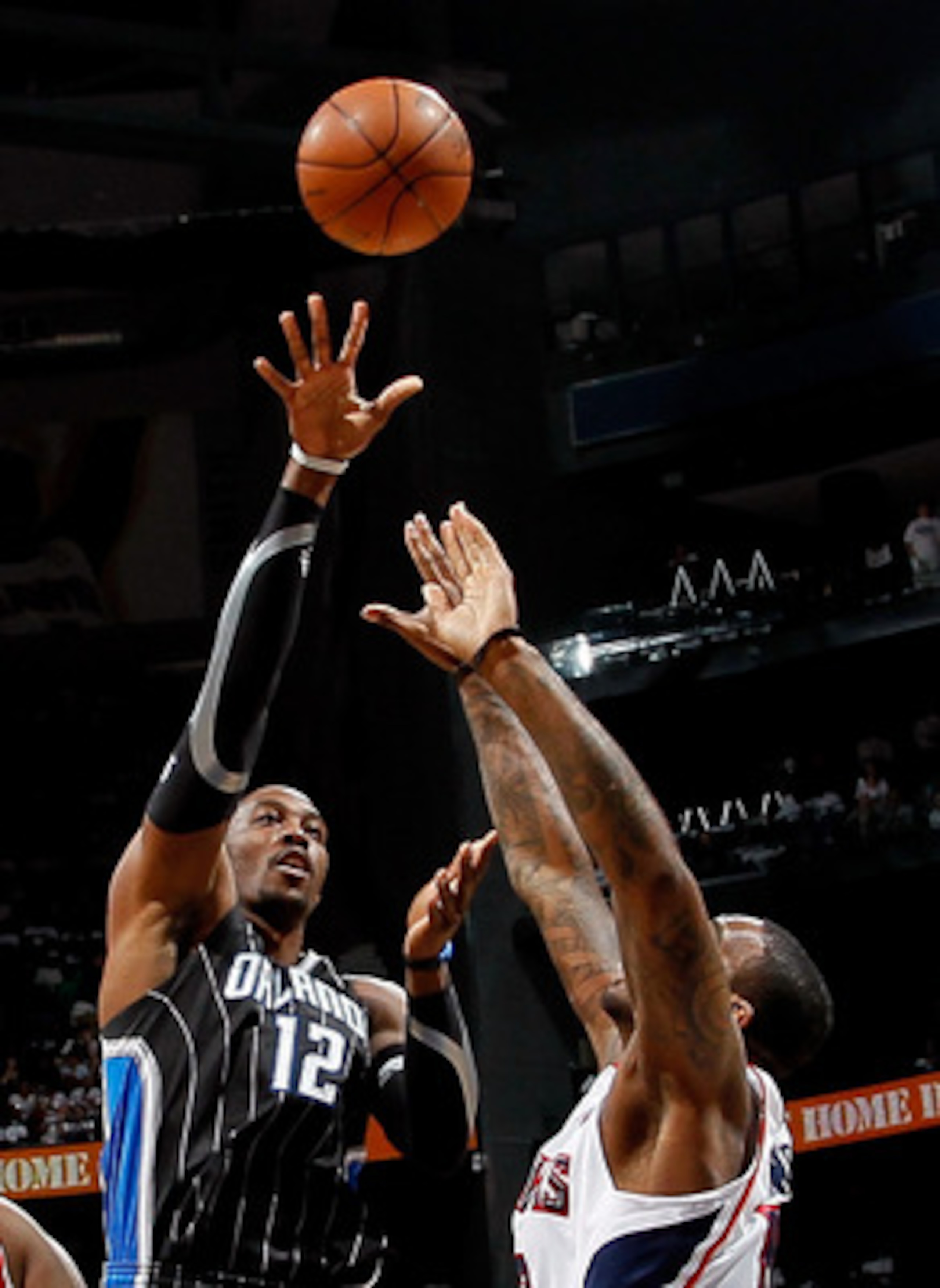 ATLANTA, GA - APRIL 24:  Dwight Howard #12 of the Orlando Magic shoots over Josh Powell #12 of the Atlanta Hawks during Game Four of the Eastern Conference Quarterfinals in the 2011 NBA Playoffs at Philips Arena on April 24, 2011 in Atlanta, Georgia.  NOT