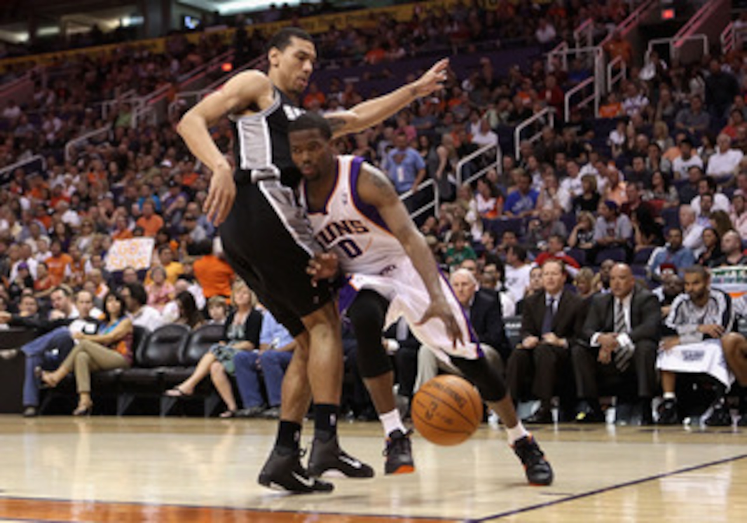 PHOENIX, AZ - APRIL 13:  Aaron Brooks #0 of the Phoenix Suns drives the ball against George Hill #4 of the San Antonio Spurs during the NBA game at US Airways Center on April 13, 2011 in Phoenix, Arizona.  NOTE TO USER: User expressly acknowledges and agr