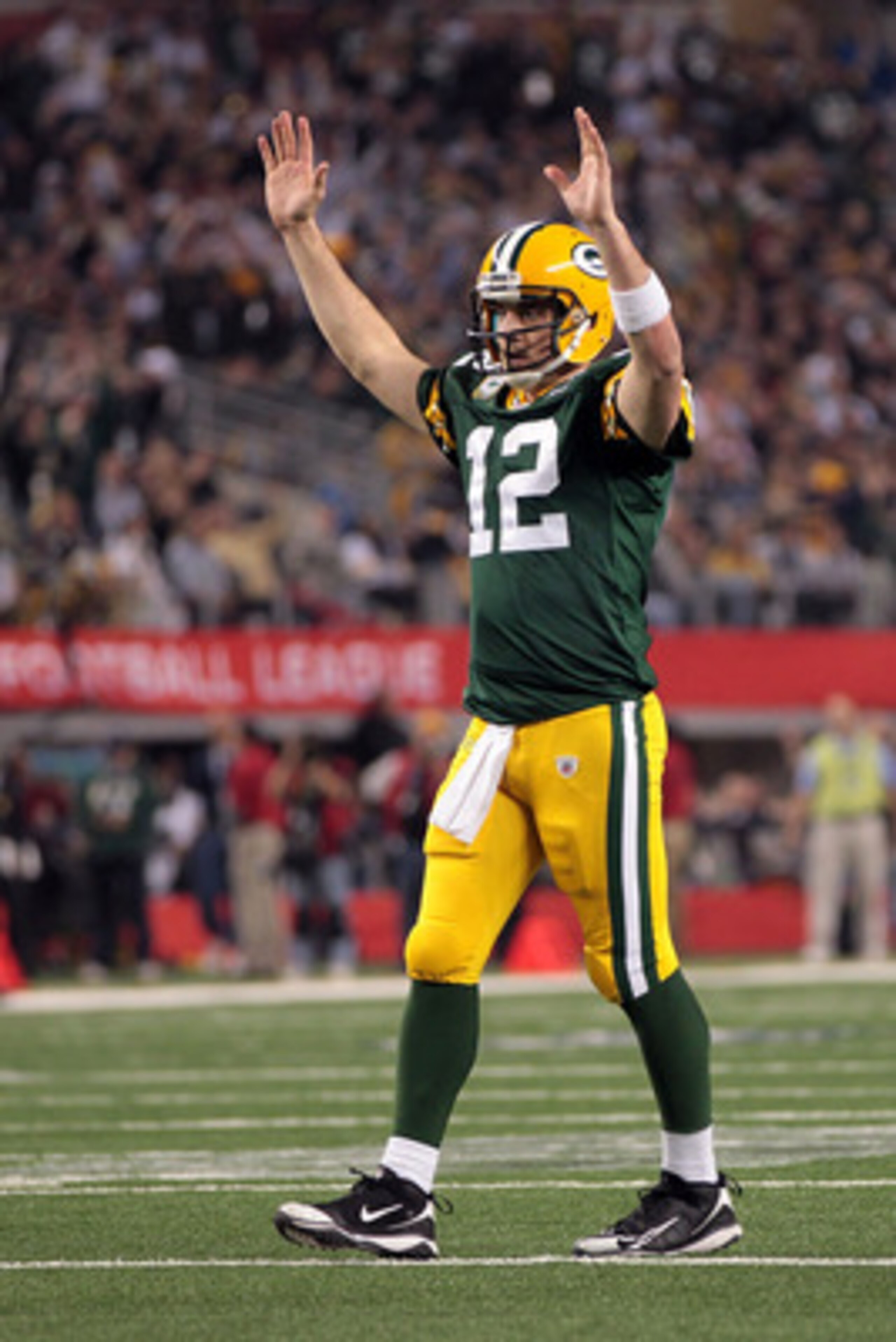 ARLINGTON, TX - FEBRUARY 06: Aaron Rodgers #12 of the Green Bay Packers celebrates after an 8 yard touchdown pass to Greg Jennings against the Pittsburgh Steelers during Super Bowl XLV at Cowboys Stadium on February 6, 2011 in Arlington, Texas.  (Photo by