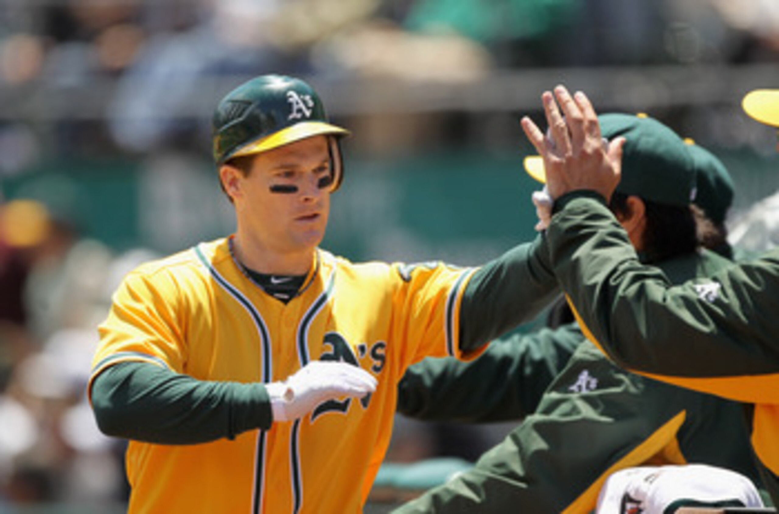 OAKLAND, CA - JUNE 01:  Josh Willingham #16 of the Oakland Athletics is congratulated by teammates after he hit a two run home run in the first inning against the New York Yankees at Oakland-Alameda County Coliseum on June 1, 2011 in Oakland, California. 