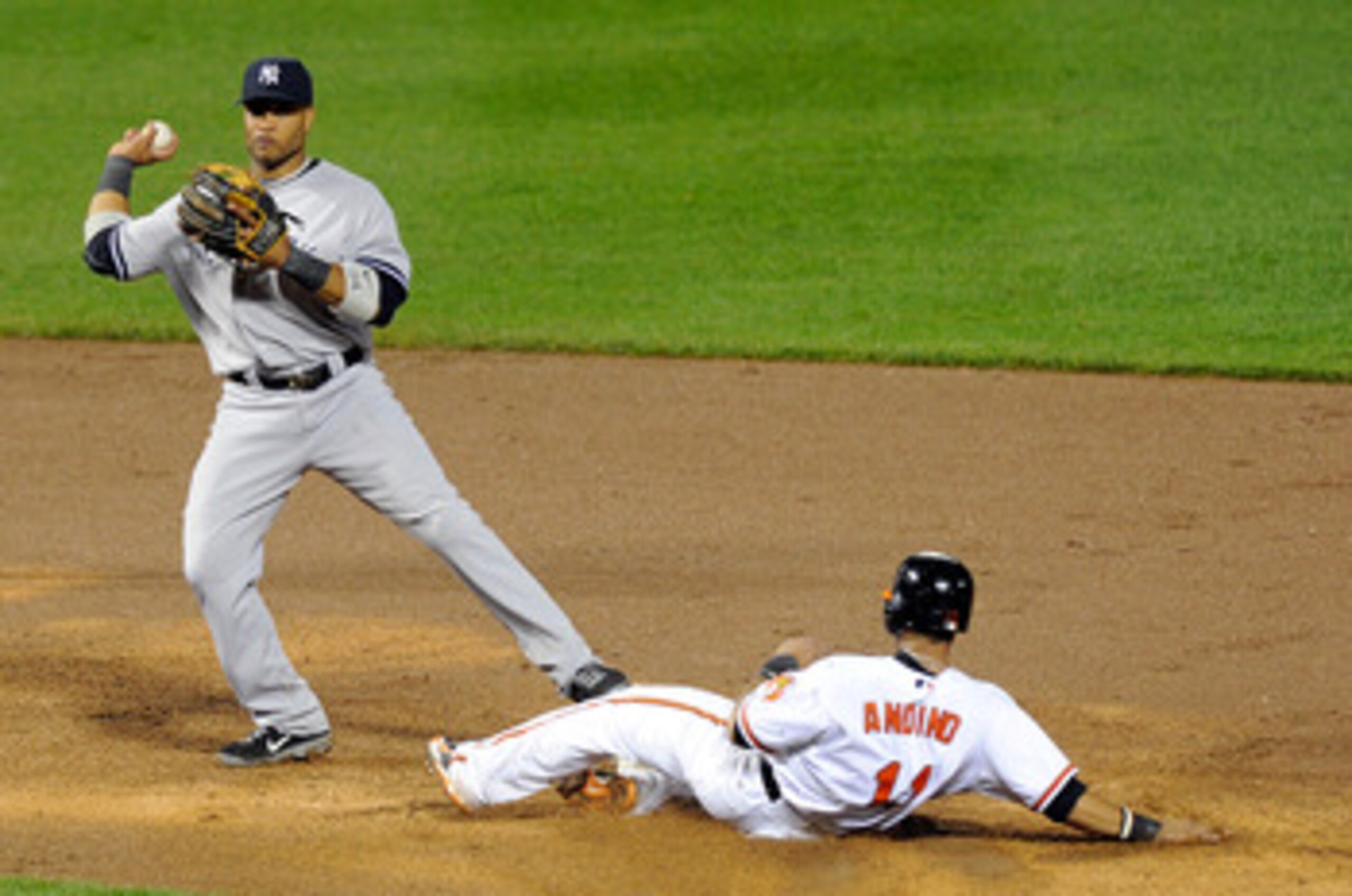BALTIMORE, MD - MAY 19: Robinson Cano #24 of the New York Yankees forces out Robert Andino #11 of the Baltimore Orioles to start a double play at Oriole Park at Camden Yards on May 19, 2011 in Baltimore, Maryland. New York won the game 13-2. (Photo by Gr BALTIMORE, MD - MAY 19: Robinson Cano #24 of the New York Yankees forces out Robert Andino #11 of the Baltimore Orioles to start a double play at Oriole Park at Camden Yards on May 19, 2011 in Baltimore, Maryland. New York won the game 13-2. (Photo by Gr