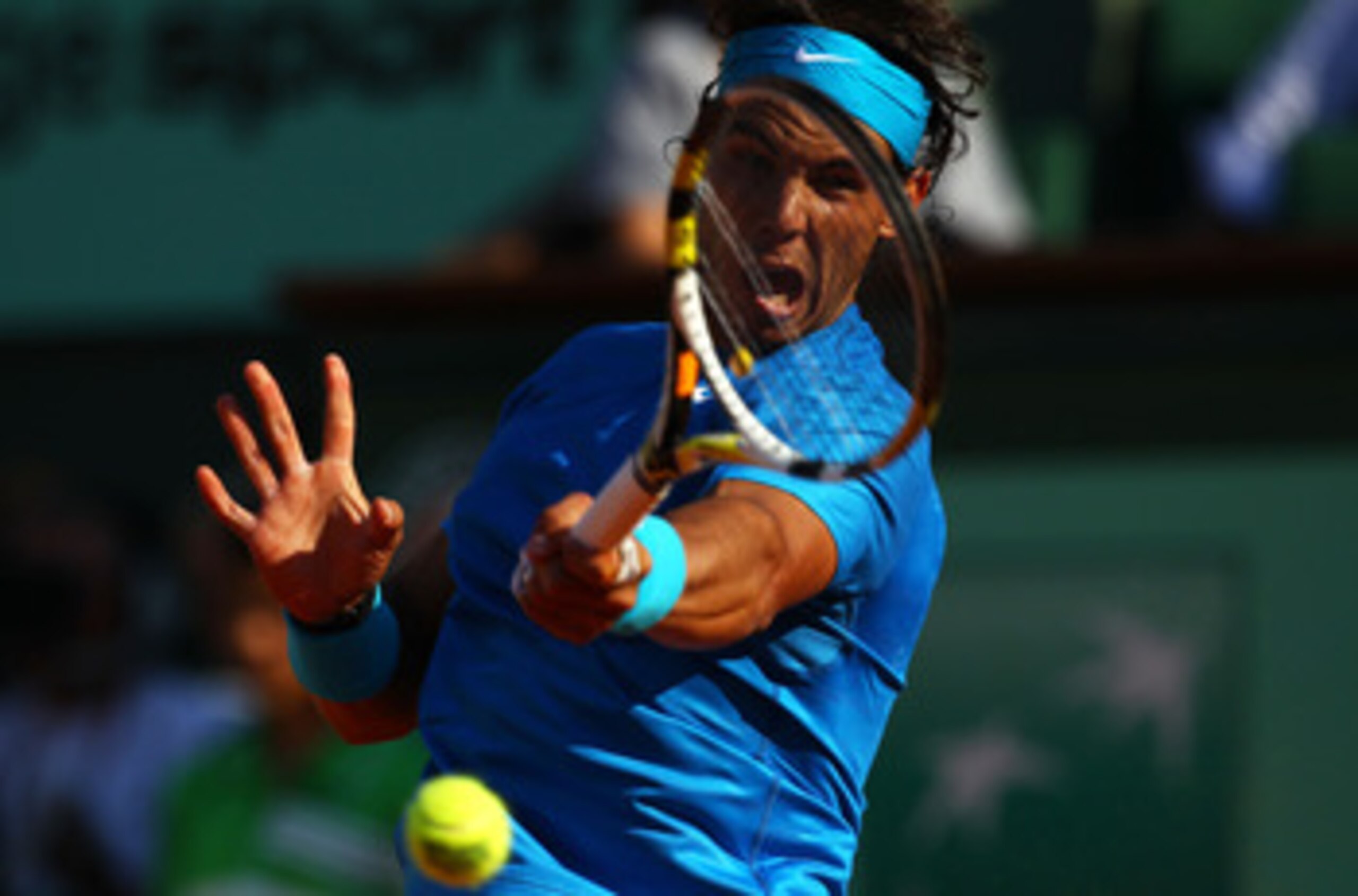 PARIS, FRANCE - JUNE 01:  Rafael Nadal of Spain hits a backhand during the men's singles quarterfinal match between Rafael Nadal of Spain and Robin Soderling of Sweden on day eleven of the French Open at Roland Garros on June 1, 2011 in Paris, France.  (P