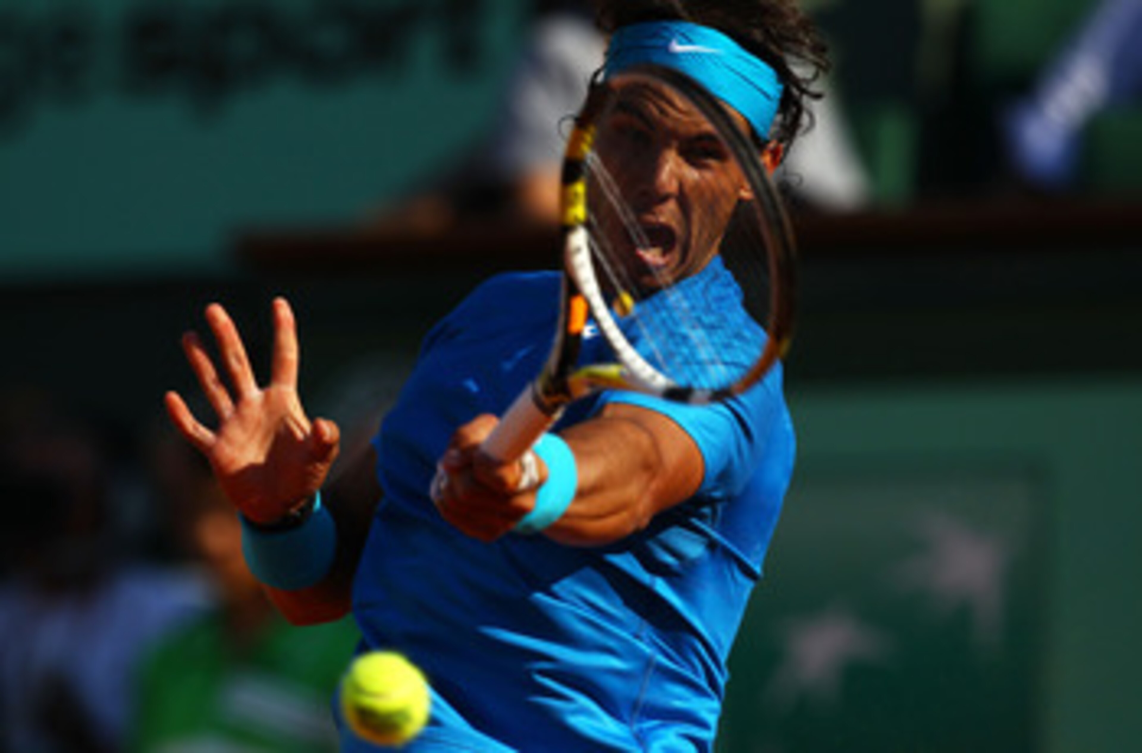 PARIS, FRANCE - JUNE 01: Rafael Nadal of Spain hits a backhand during the men's singles quarterfinal match between Rafael Nadal of Spain and Robin Soderling of Sweden on day eleven of the French Open at Roland Garros on June 1, 2011 in Paris, France. (P PARIS, FRANCE - JUNE 01: Rafael Nadal of Spain hits a backhand during the men's singles quarterfinal match between Rafael Nadal of Spain and Robin Soderling of Sweden on day eleven of the French Open at Roland Garros on June 1, 2011 in Paris, France. (P