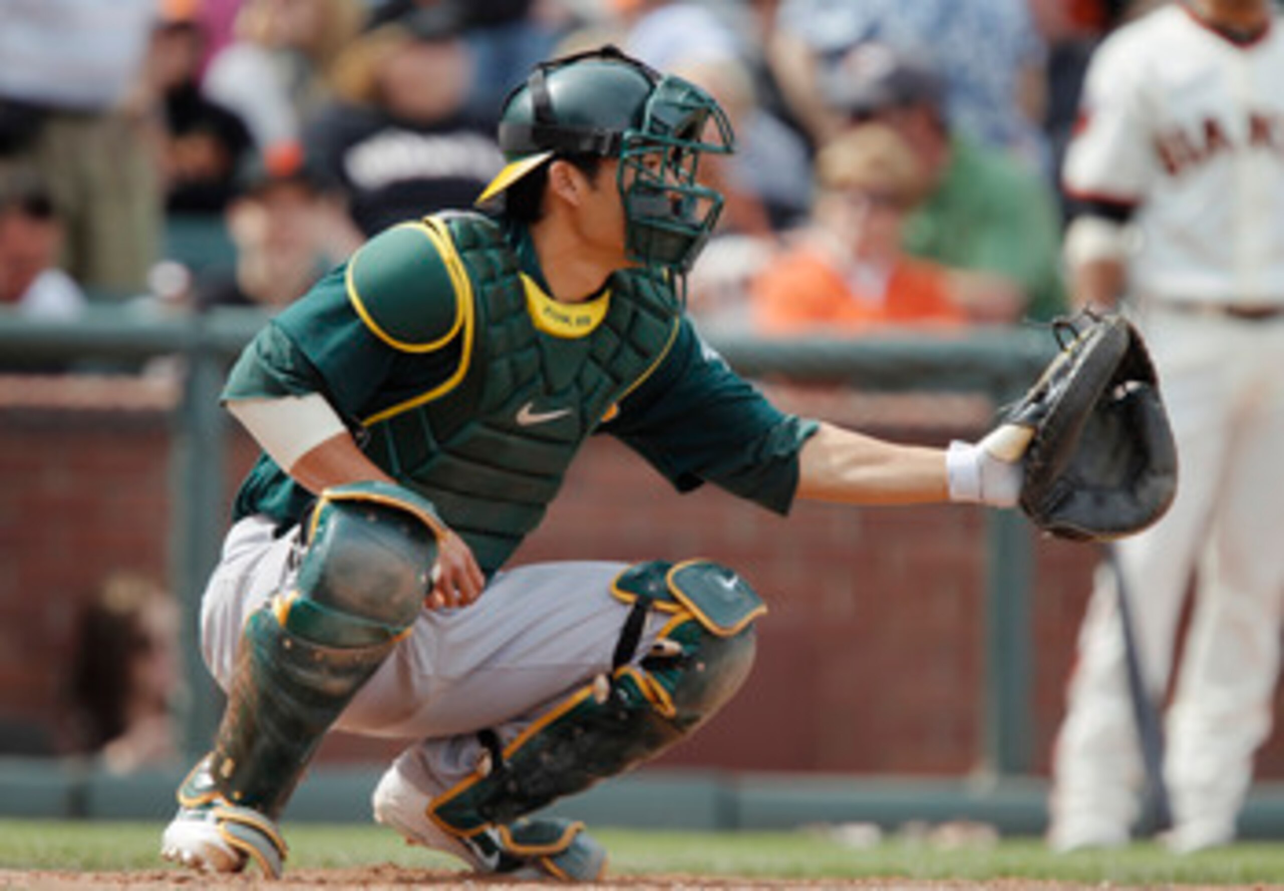 SAN FRANCISCO, CA - MAY 22:  Catcher Kurt Suzuki #8 of the Oakland A's catches against the San Francisco Giants at AT&T Park on May 22, 2011 in San Francisco, California.  The Giants won 5-4.  (Photo by Brian Bahr/Getty Images)