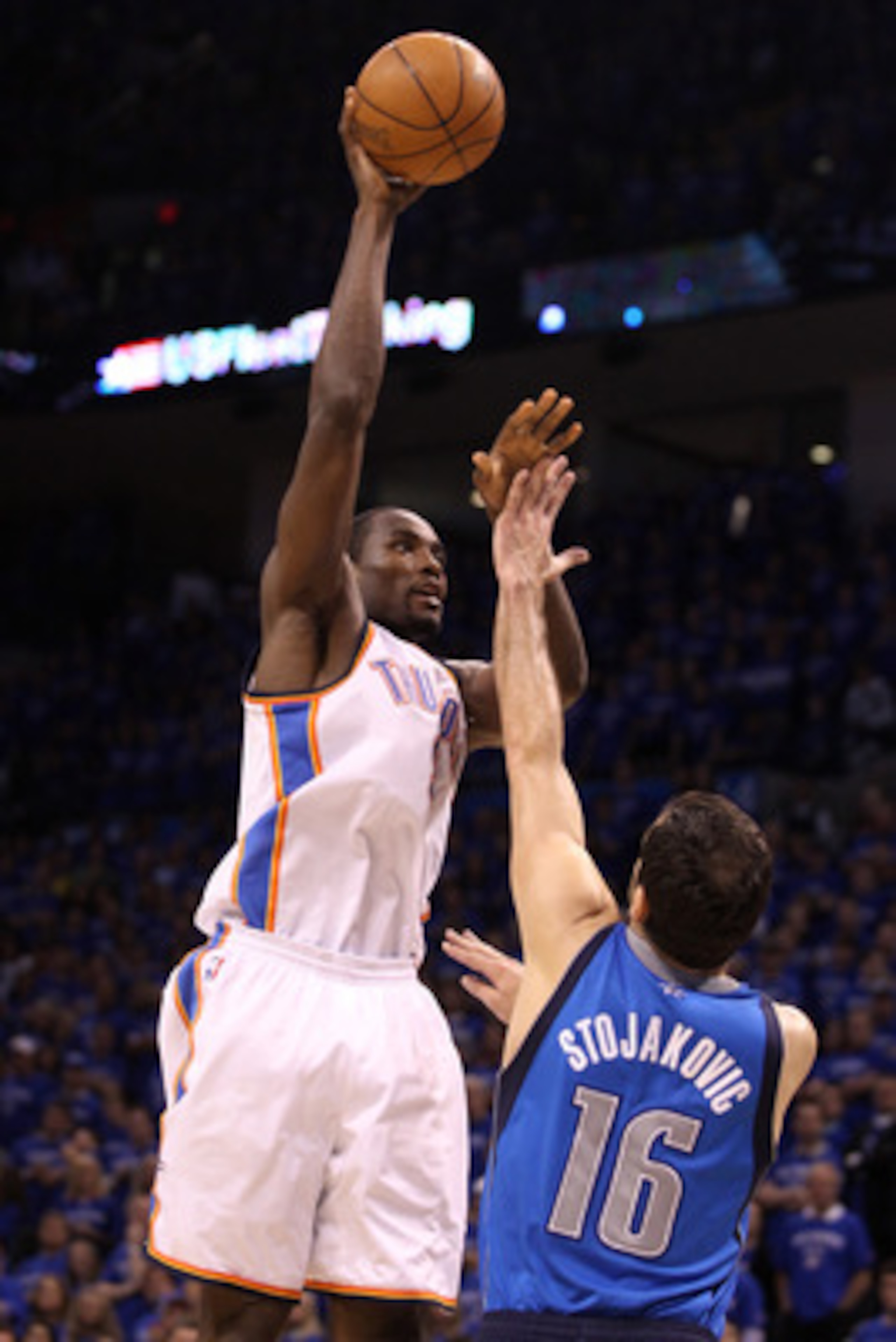 OKLAHOMA CITY, OK - MAY 23:  Serge Ibaka #9 of the Oklahoma City Thunder shoots over Peja Stojakovic #16 of the Dallas Mavericks in the second half in Game Four of the Western Conference Finals during the 2011 NBA Playoffs at Oklahoma City Arena on May 23