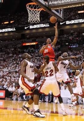 MIAMI, FL - APRIL 27: Thaddeus Young #21 of the Philadelphia 76ers shoots over James Jones #22 and Joel Anthony #50 of the Miami Heat during game five of the Eastern Conference Quarterfinals in the 2011 NBA Playoffs at American Airlines Arena on April 27,