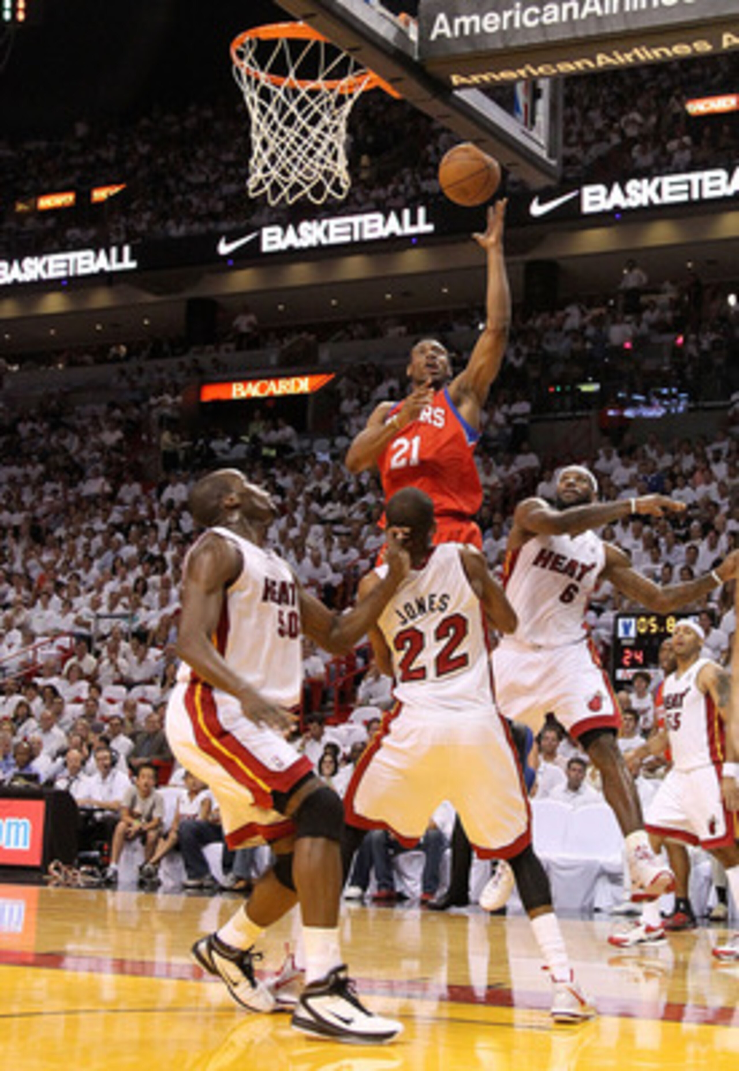 MIAMI, FL - APRIL 27: Thaddeus Young #21 of the Philadelphia 76ers shoots over James Jones #22 and Joel Anthony #50 of the Miami Heat during game five of the Eastern Conference Quarterfinals in the 2011 NBA Playoffs at American Airlines Arena on April 27,
