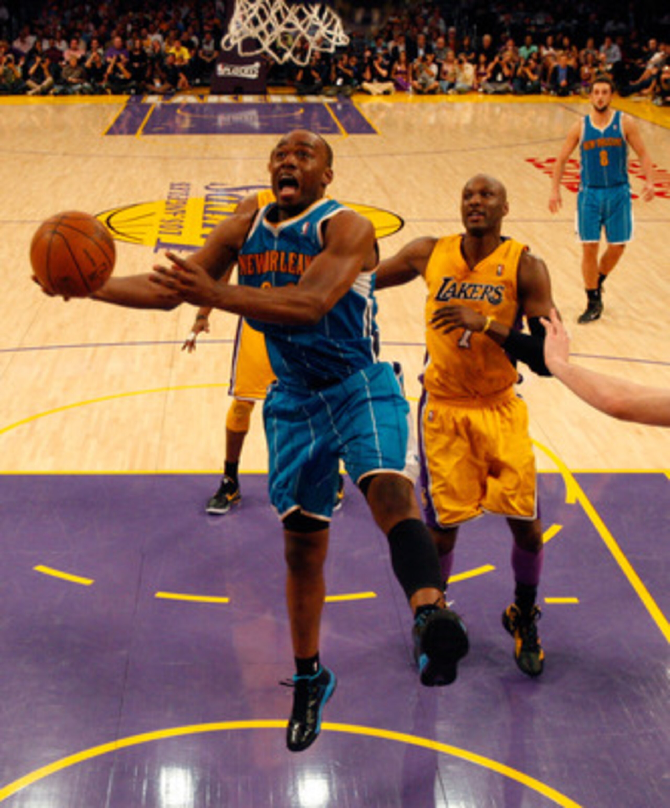 LOS ANGELES, CA - APRIL 26:  Carl Landry #24 of the New Orleans Hornets goes up for a layup in front of Lamar Odom #7 of the Los Angeles Lakers in the second half in Game Five of the Western Conference Quarterfinals in the 2011 NBA Playoffs on April 26, 2