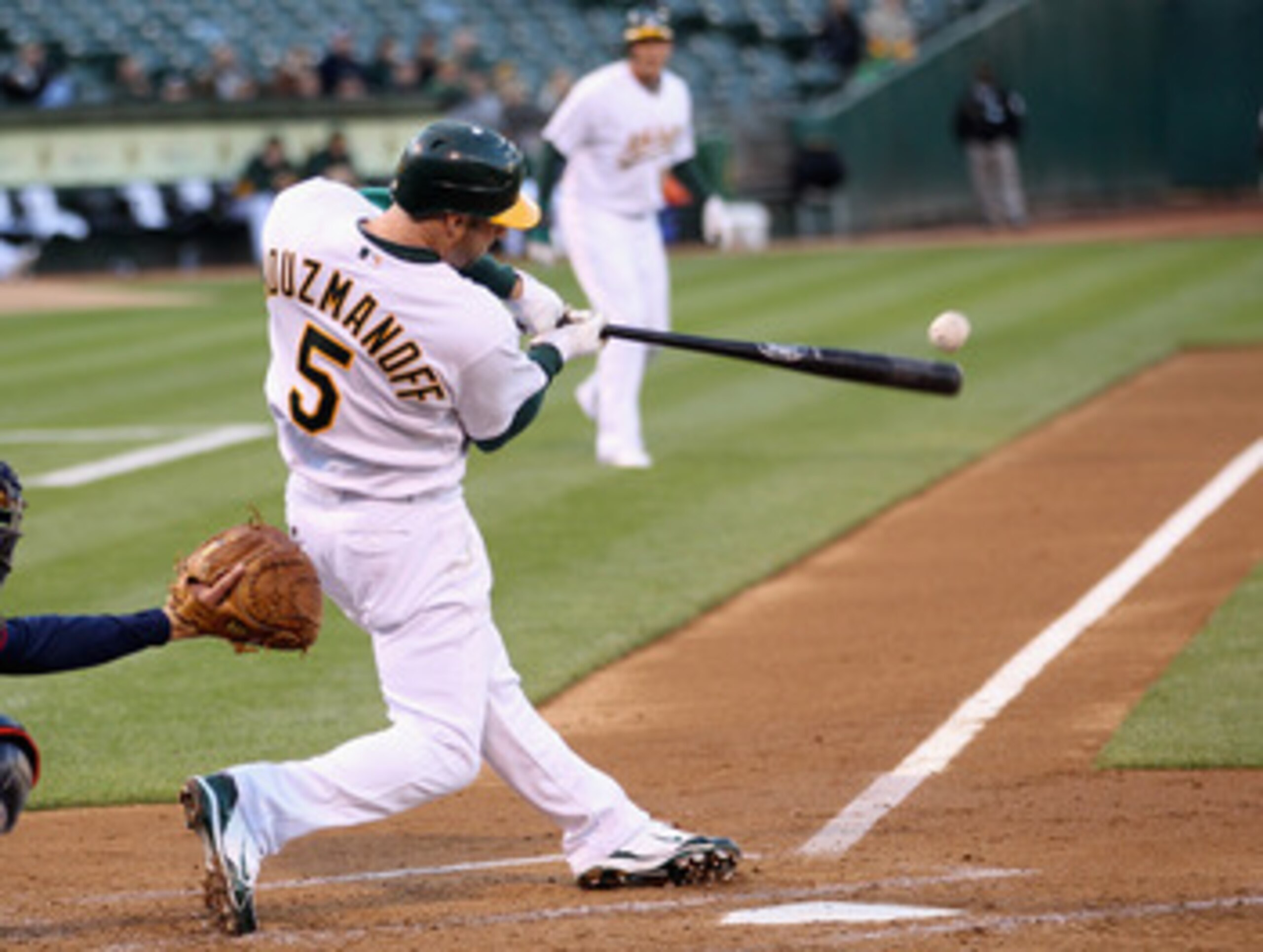 OAKLAND, CA - MAY 18:  Kevin Kouzmanoff #5 of the Oakland Athletics singles in two runs in the second inning against the Minnesota Twins at Oakland-Alameda County Coliseum on May 18, 2011 in Oakland, California.  (Photo by Ezra Shaw/Getty Images)