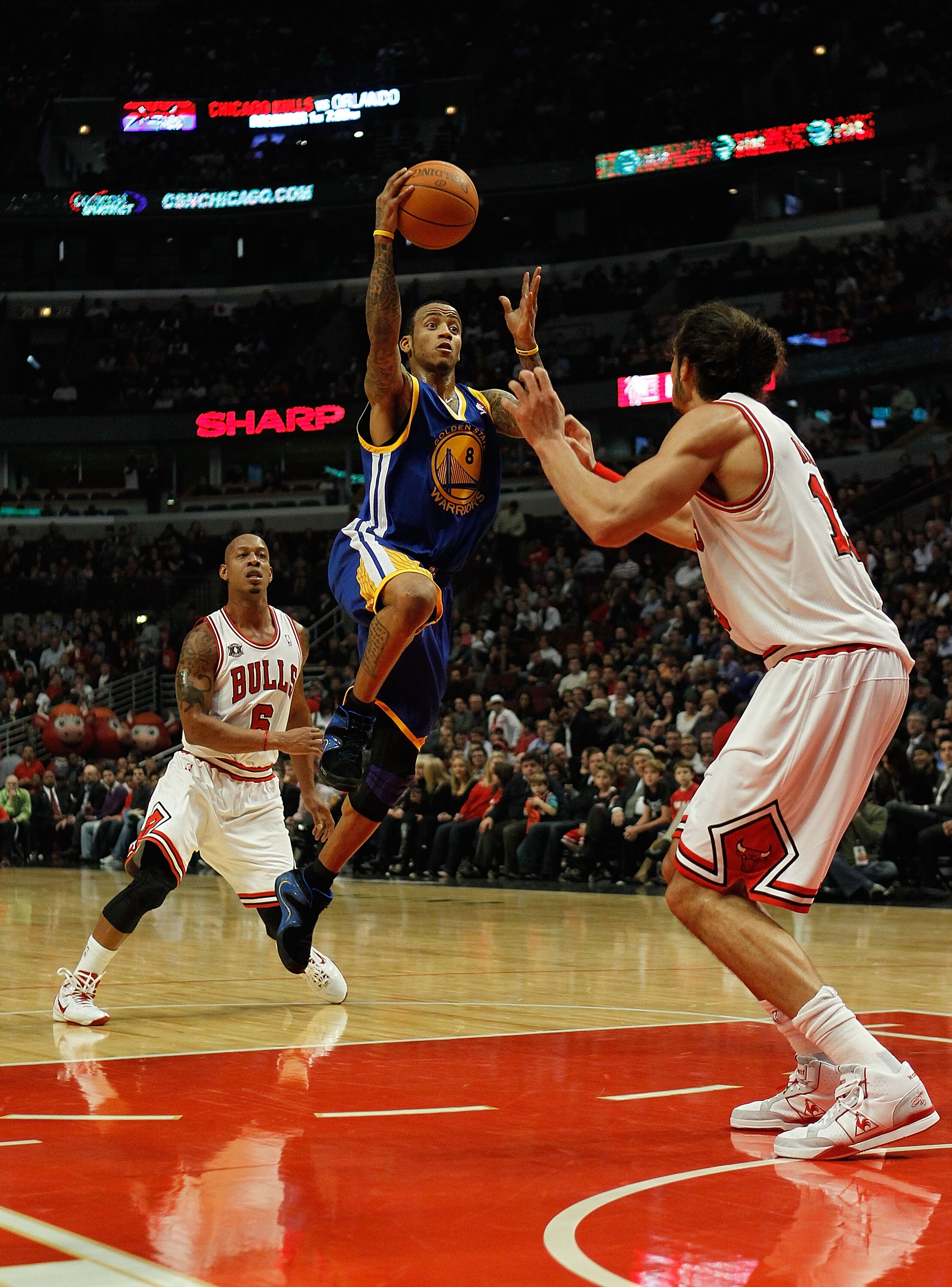 CHICAGO - NOVEMBER 11: Monta Ellis #8 of the Golden State Warriors puts up a shot between Keith Bogans #6 and Joakim Noah #13 of the Chicago Bulls at the United Center on November 11, 2010 in Chicago, Illinois. NOTE TO USER: User expressly acknowledges an