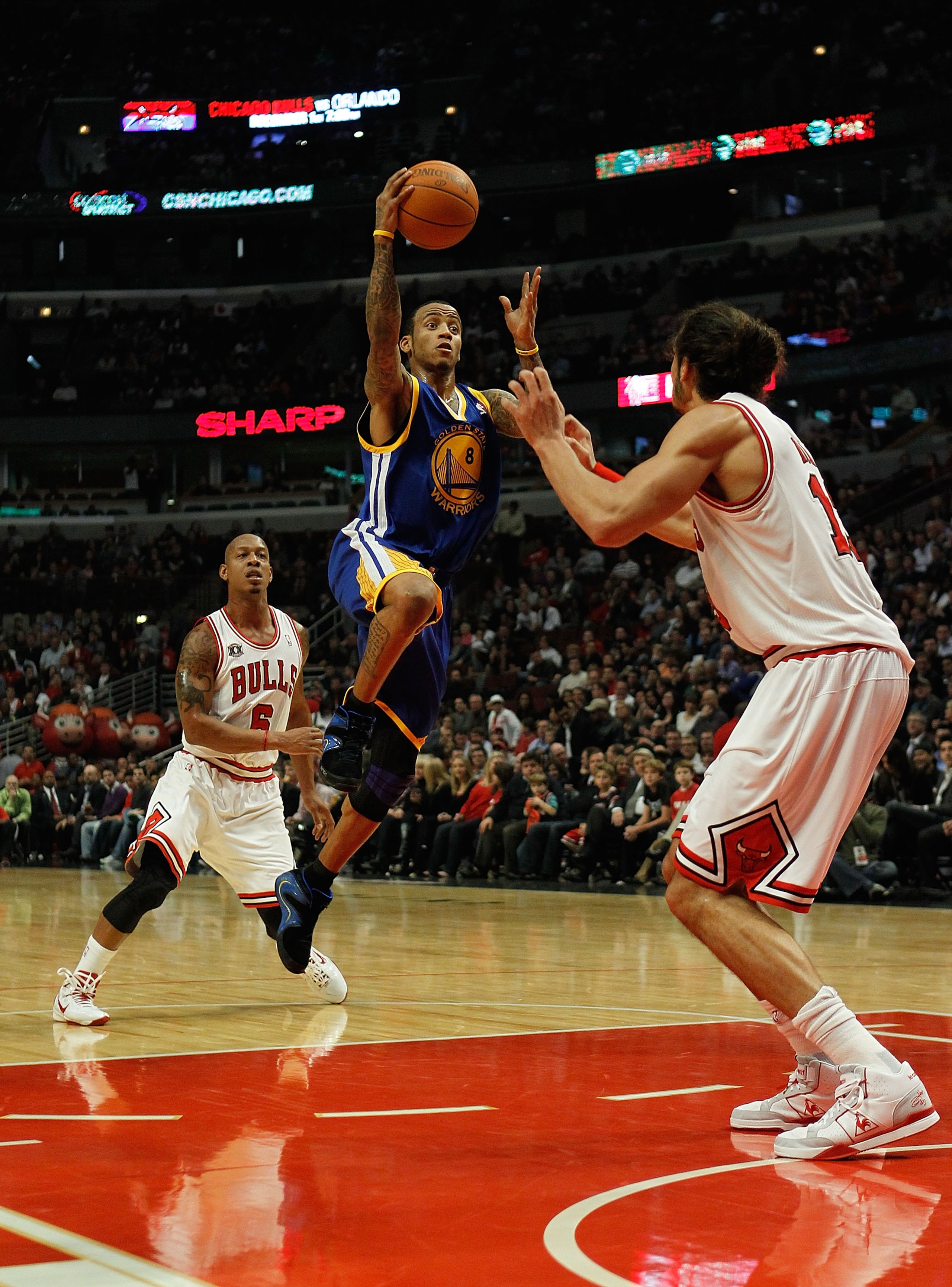 CHICAGO - NOVEMBER 11: Monta Ellis #8 of the Golden State Warriors puts up a shot between Keith Bogans #6 and Joakim Noah #13 of the Chicago Bulls at the United Center on November 11, 2010 in Chicago, Illinois. NOTE TO USER: User expressly acknowledges an