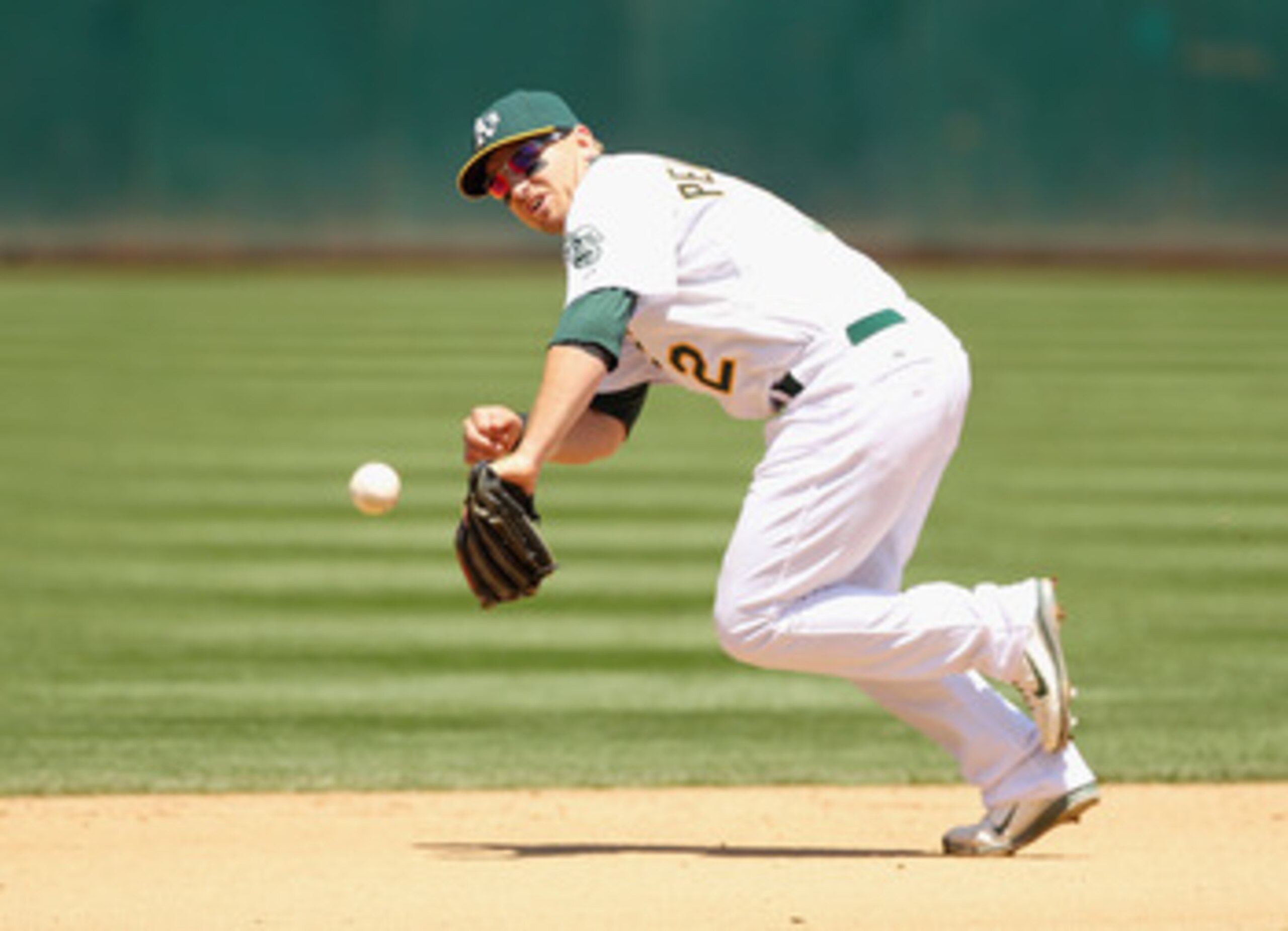 OAKLAND, CA - MAY 29:  Cliff Pennington #2 of the Oakland Athletics tries to field a ground ball during their game against the Baltimore Orioles at Oakland-Alameda County Coliseum on May 29, 2011 in Oakland, California.  (Photo by Ezra Shaw/Getty Images)