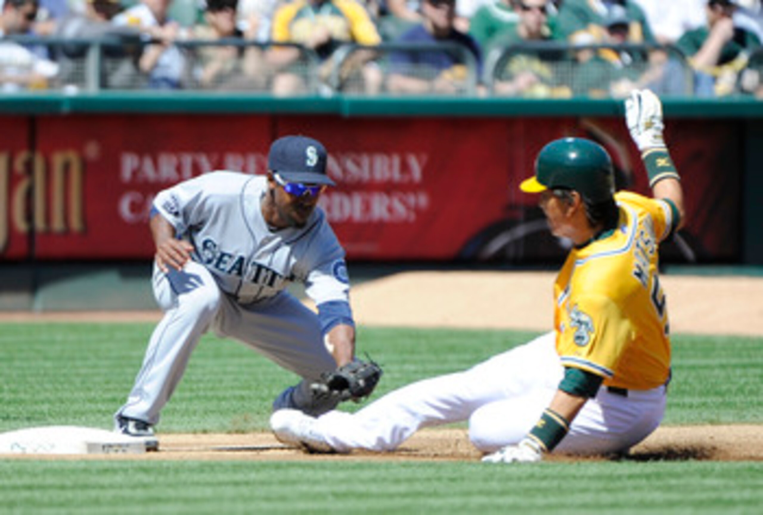 OAKLAND, CA - APRIL 3: Hideki Matsui #55 of the Oakland Athletics trying to take third base on fly-ball is tagged out by Chone Figgins #9 of the Seattle Mariners during a MLB baseball game at the Oakland-Alameda County Coliseum April 3, 2011 in Oakland, C OAKLAND, CA - APRIL 3: Hideki Matsui #55 of the Oakland Athletics trying to take third base on fly-ball is tagged out by Chone Figgins #9 of the Seattle Mariners during a MLB baseball game at the Oakland-Alameda County Coliseum April 3, 2011 in Oakland, C