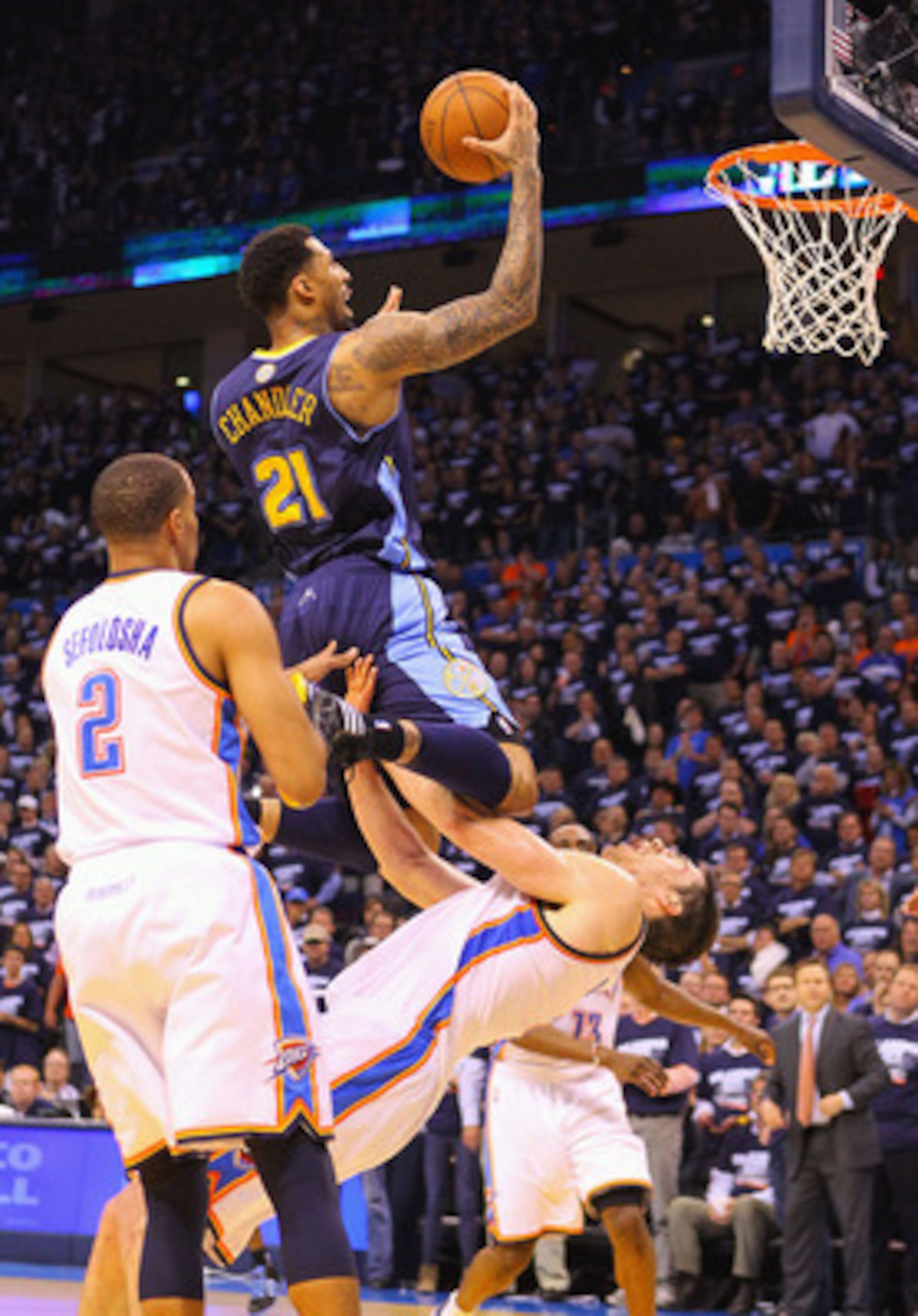 OKLAHOMA CITY, OK - APRIL 27: Wilson Chandler #21 of the Denver Nuggets drives to the basket against Nick Collison #4 of the Oklahoma City Thunder in Game Five of the Western Conference Quarterfinals in the 2011 NBA Playoffs on April 27, 2011 at the Ford OKLAHOMA CITY, OK - APRIL 27: Wilson Chandler #21 of the Denver Nuggets drives to the basket against Nick Collison #4 of the Oklahoma City Thunder in Game Five of the Western Conference Quarterfinals in the 2011 NBA Playoffs on April 27, 2011 at the Ford