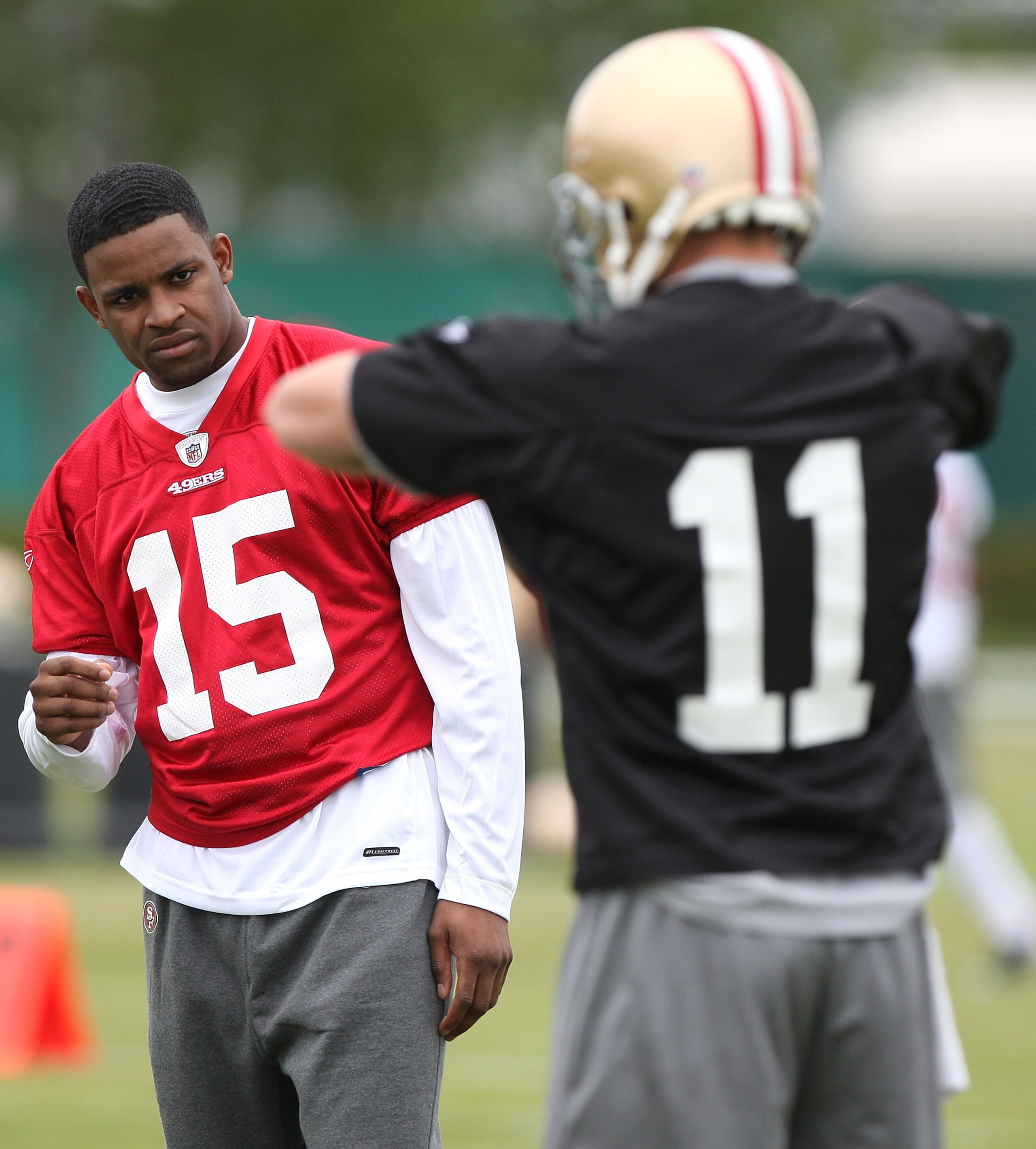 SANTA CLARA, CA - MAY 01:  Michael Crabtree #15 of the San Francisco 49ers looks on during practice as quaterback Alex Smith #11 practices during the 49ers Minicamp at their training facilities on May 1, 2009 in Santa Clara, California. Crabtree was the 4