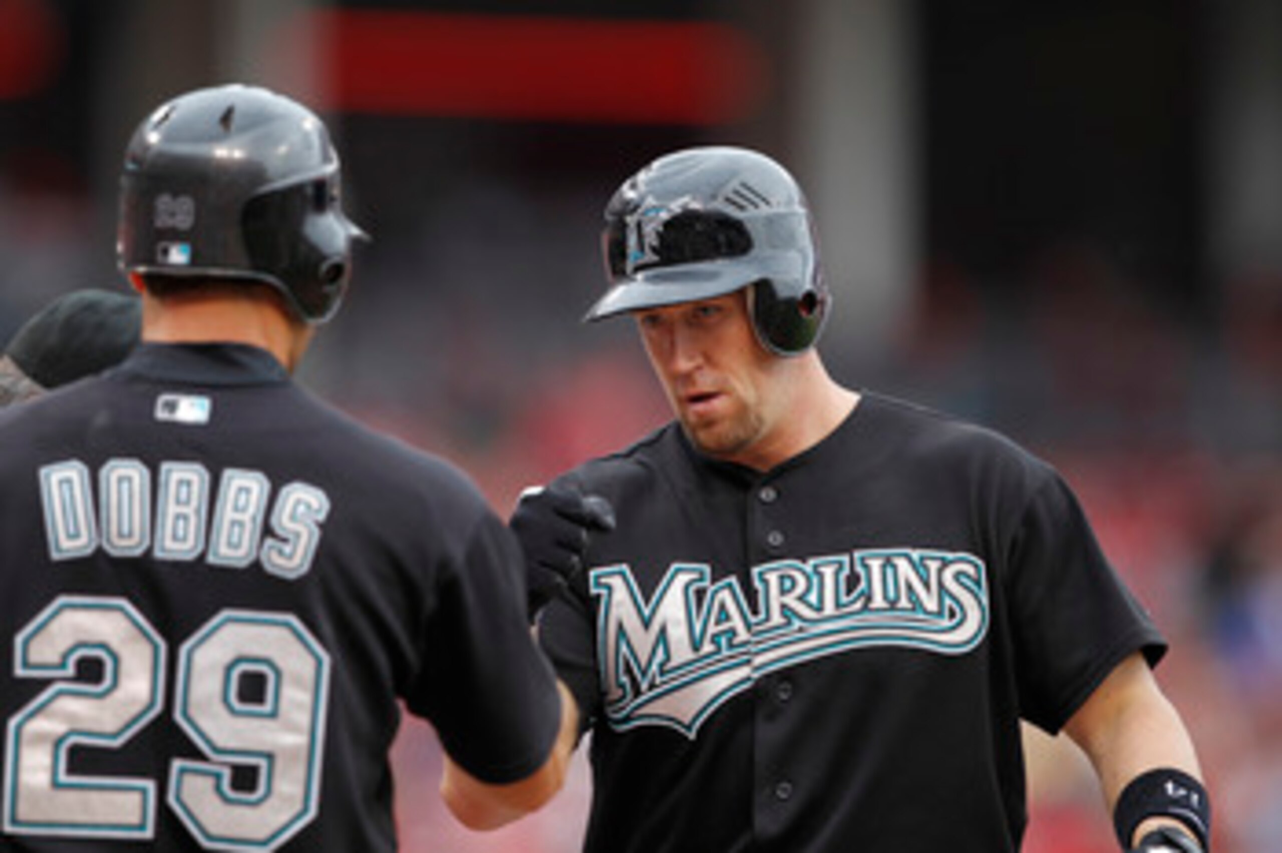 CINCINNATI, OH - MAY 1: John Buck #14 of the Florida Marlins celebrates with Greg Dobbs #29 after hitting a home run in the seventh inning against the Cincinnati Reds at Great American Ball Park on May 1, 2011 in Cincinnati, Ohio. The Marlins defeated the