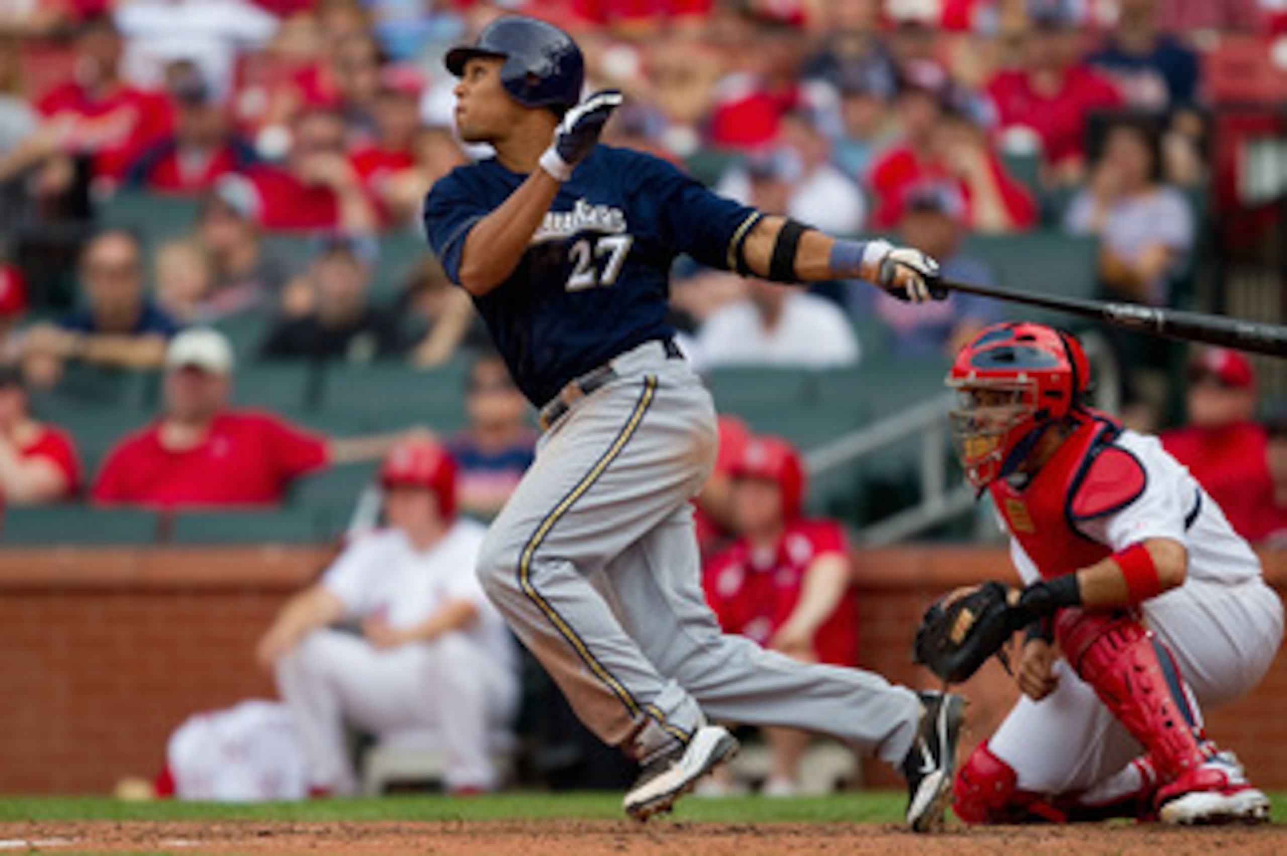 ST. LOUIS, MO - MAY 7: Carlos Gomez #27 of the Milwaukee Brewers hits a two RBI triple against the St. Louis Cardinals at Busch Stadium on May 7, 2011 in St. Louis, Missouri.  (Photo by Dilip Vishwanat/Getty Images)