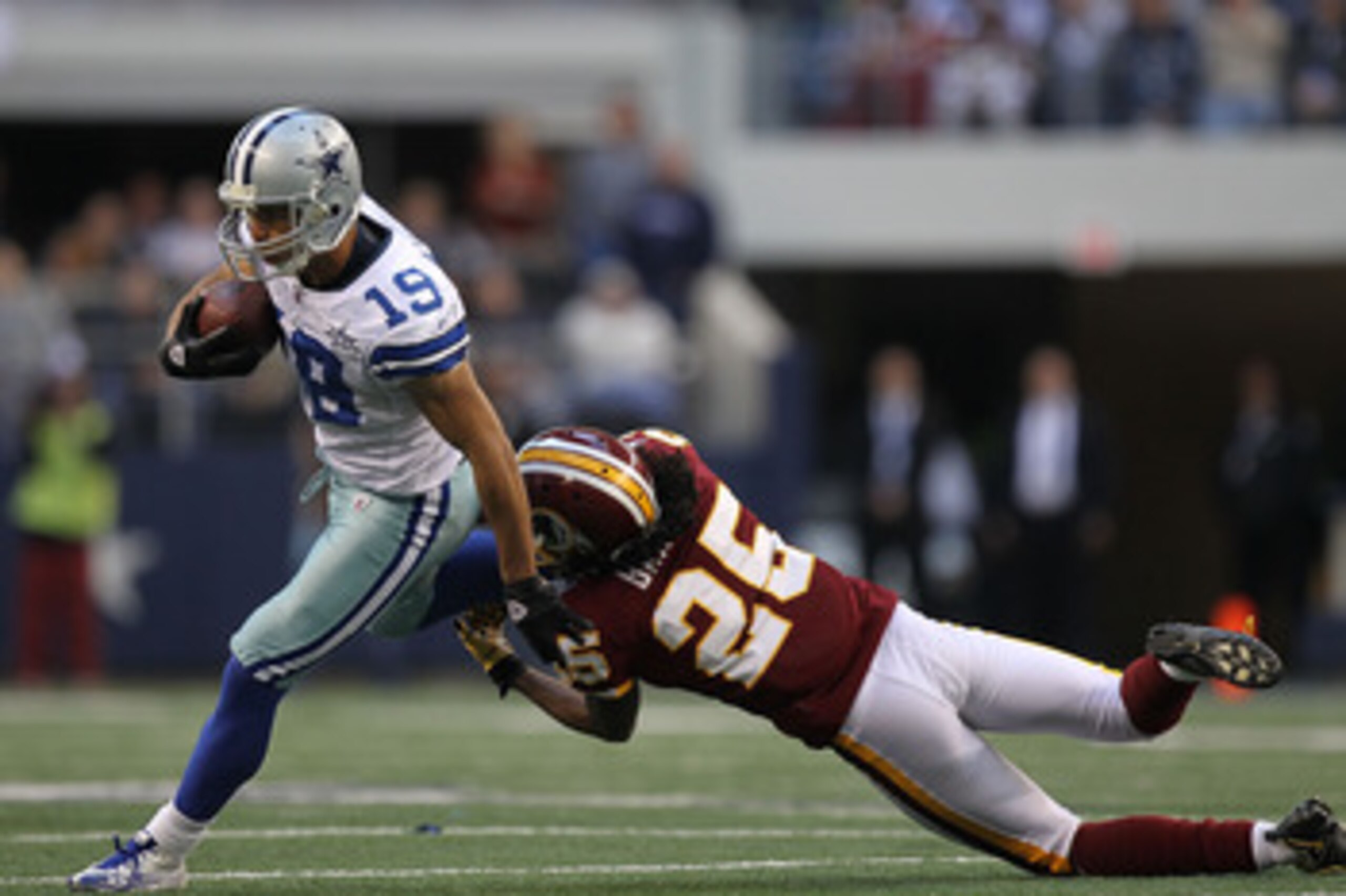 ARLINGTON, TX - DECEMBER 19:  Wide receiver Miles Austin #19 of the Dallas Cowboys runs the ball against Kevin Barnes #25 of the Washington Redskins at Cowboys Stadium on December 19, 2010 in Arlington, Texas.  (Photo by Ronald Martinez/Getty Images)